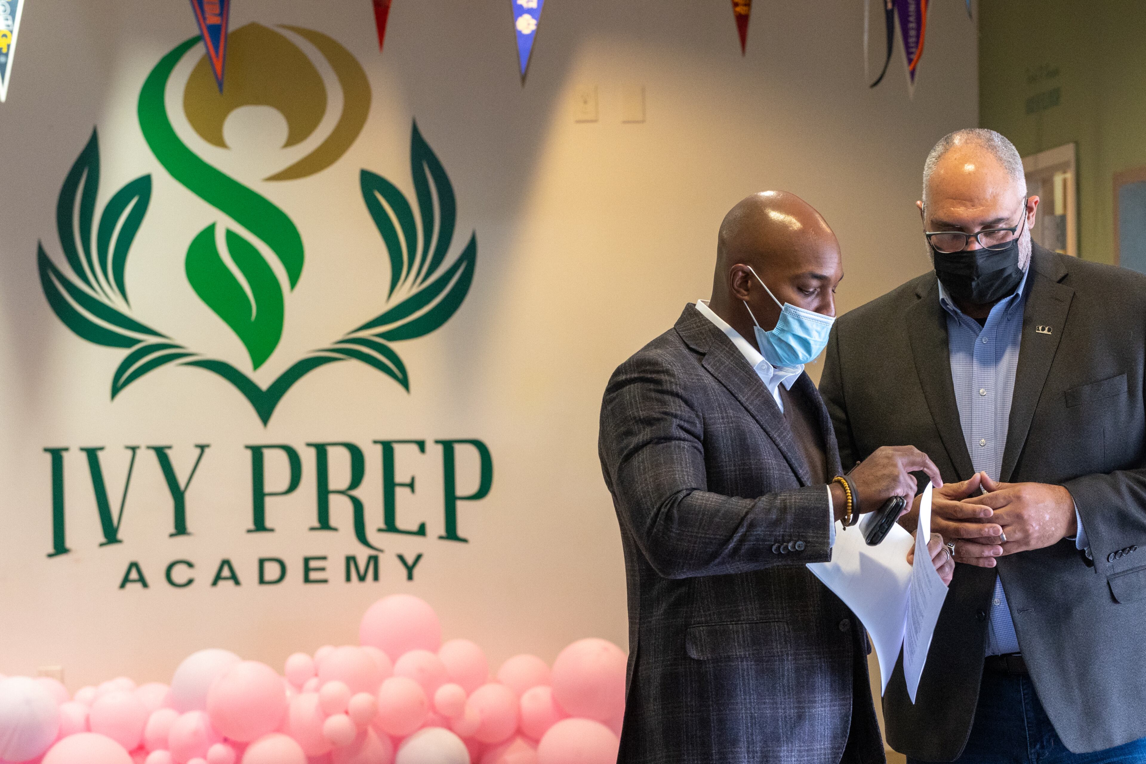 Members of 100 Black Men, including Joshua Byrd, left, and Executive Director Louis Negron, right, participate in a mentor program at Ivy Prep Academy aimed at preventing gun violence on Wednesday, March 16, 2022. The program provides several weeks of after-school education in conflict resolution, personal choices, social media pitfalls and offers a student billboard competition while spreading awareness of gun violence. (Jenni Girtman for The Atlanta Journal Constitution)