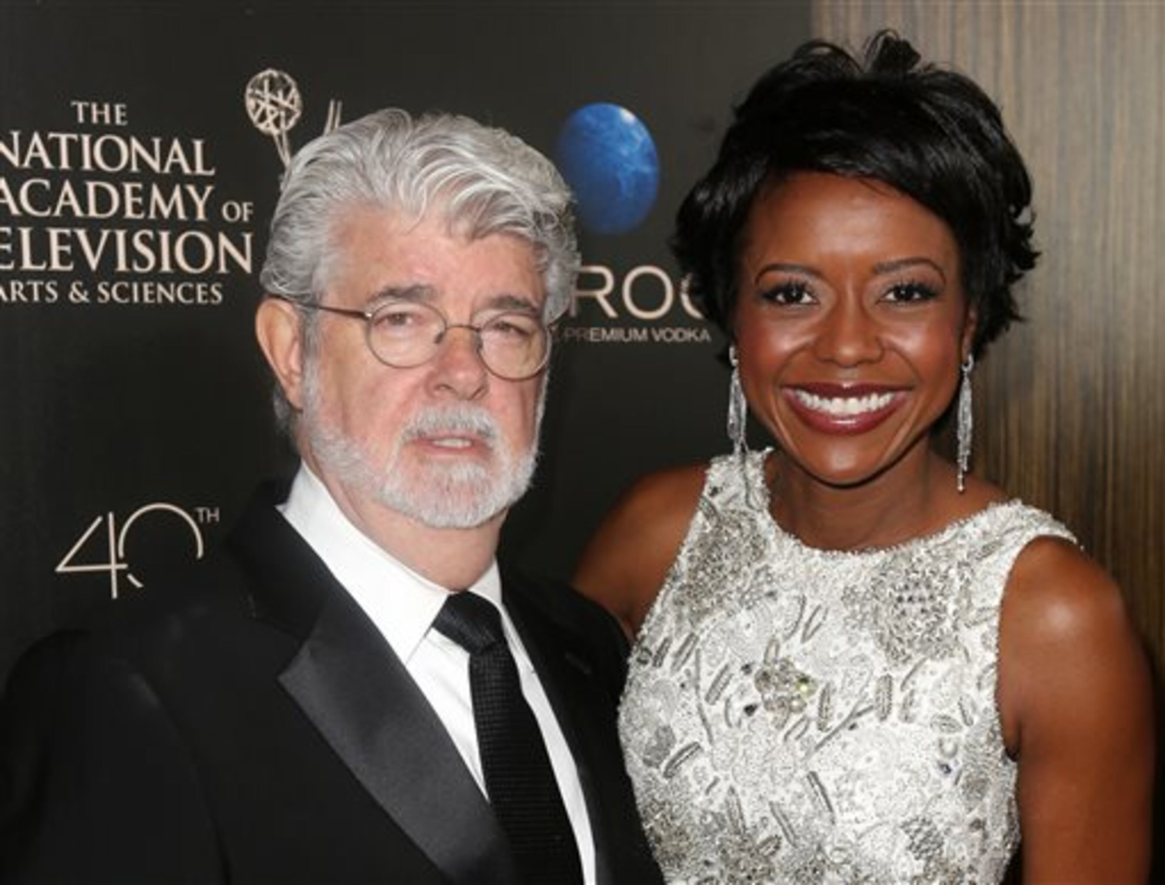 FILE - This June 16, 2013 file photo released by Entertainment Fusion Group shows producer George Lucas, left, and his wife Mellody Hobson at The 40th Annual Daytime Emmy Awards in Beverly Hills. Lucas and his wife Mellody Hobson have had a baby daughter, born via surrogate. Representatives for the 69-year-old filmmaker announced the birth Monday, Aug. 12. Everest Hobson Lucas was born Friday, the first child for Lucas and Hobson, who were married in June. (AP Photo/Entertainment Fusion Group, Ryan Miller)