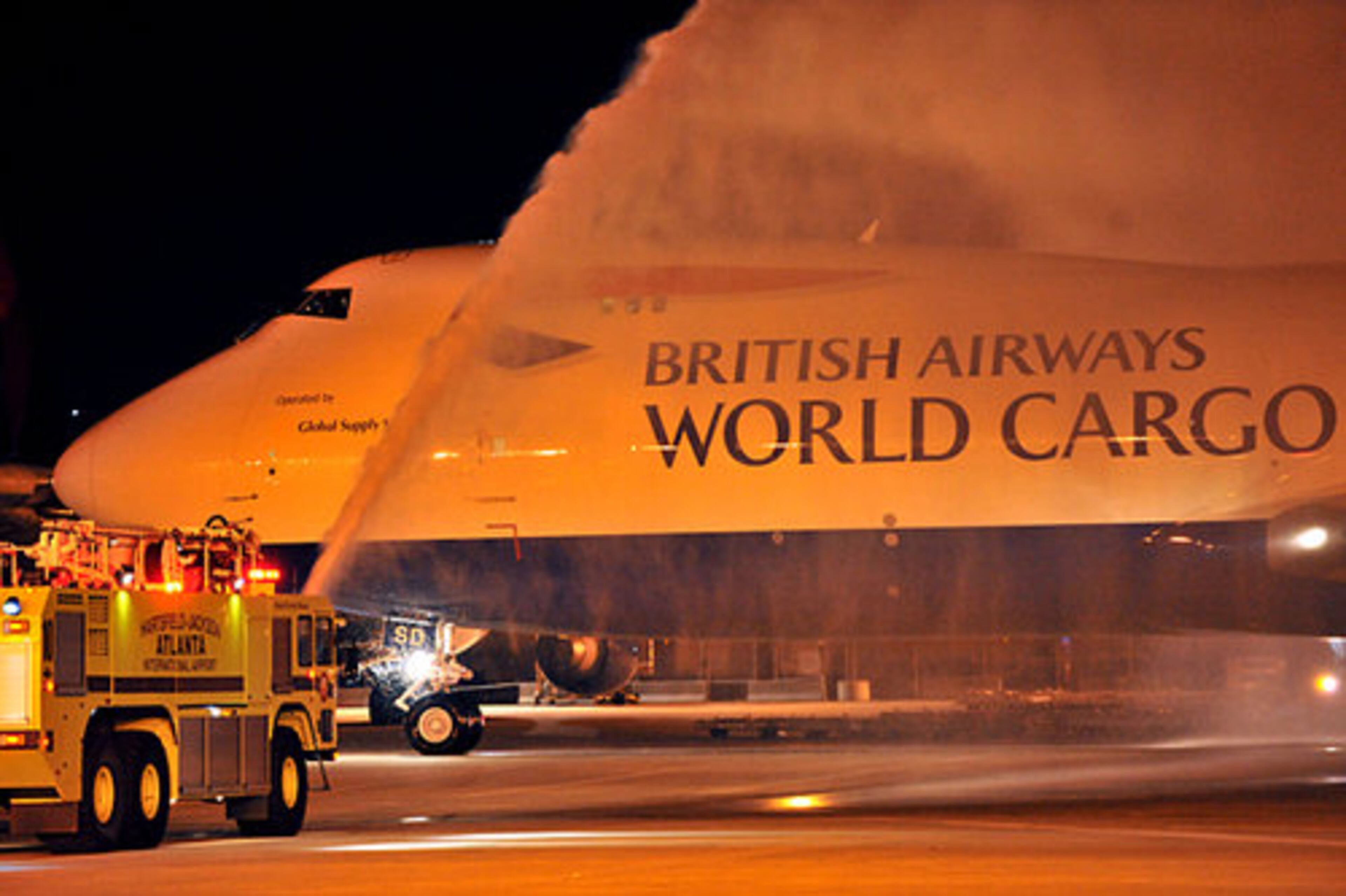 The jet rolls off under a water salute.