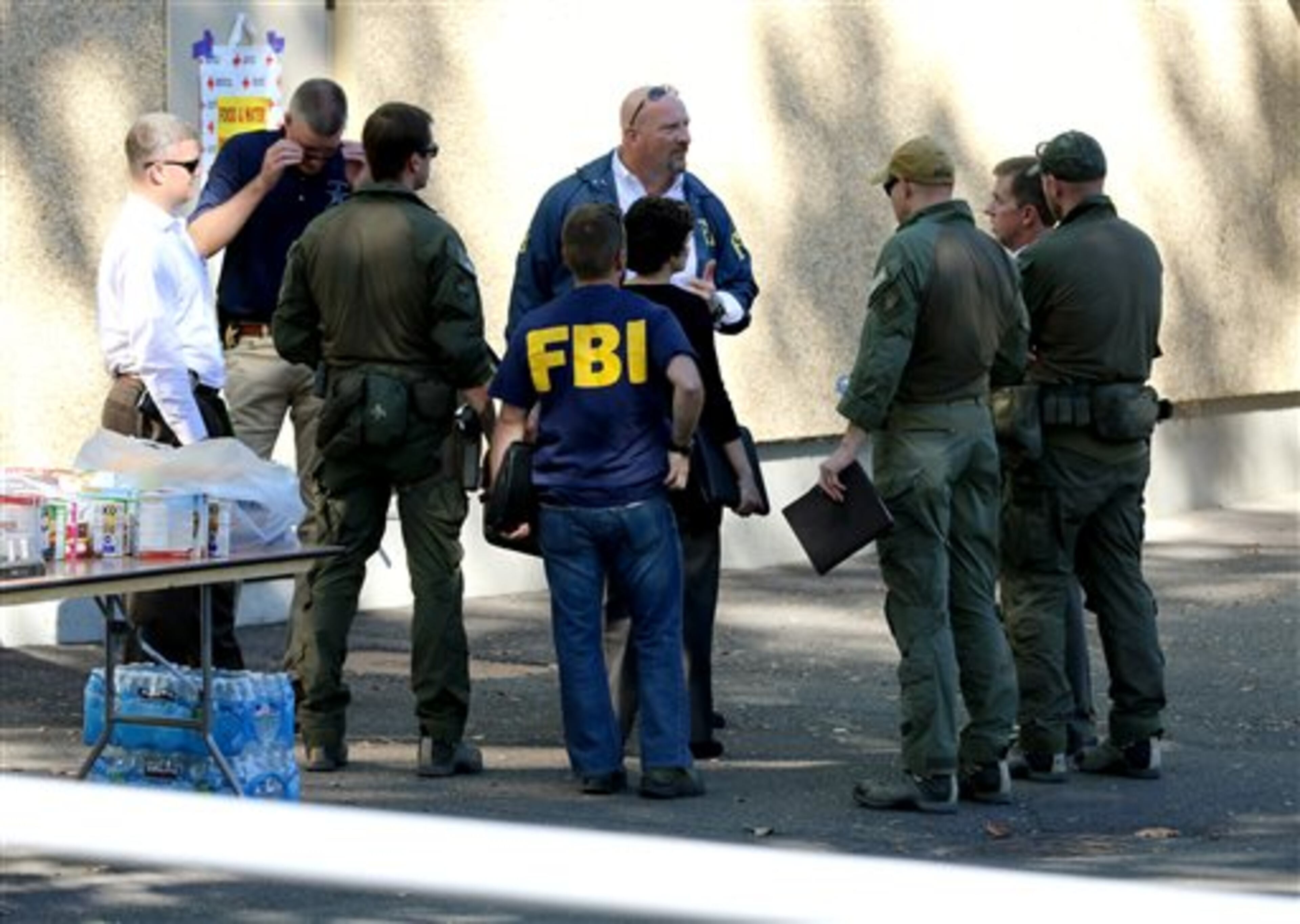 Click on this link for updates on the Oregon school shooting. Members of law enforcement have a meeting at the local fairgrounds after a deadly shooting at Umpqua Community College, in Roseburg, Ore., Thursday, Oct. 1, 2015. (AP Photo/Ryan Kang)