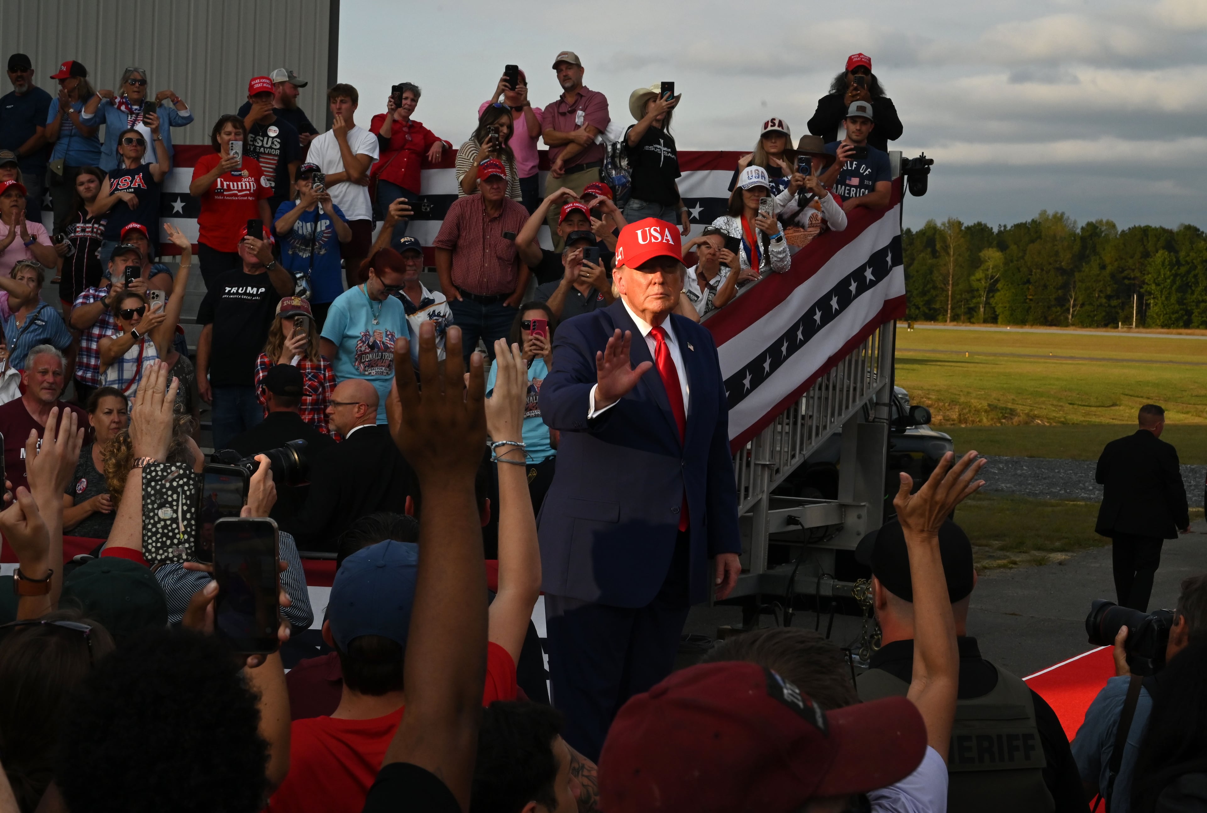 President Donald Trump waves to supporters as he leaves the stage at the end of a campaign rally at Dalton Municipal Airport on Friday, Oct. 16, 2026, in Dalton. (Hyosub Shin/AJC)