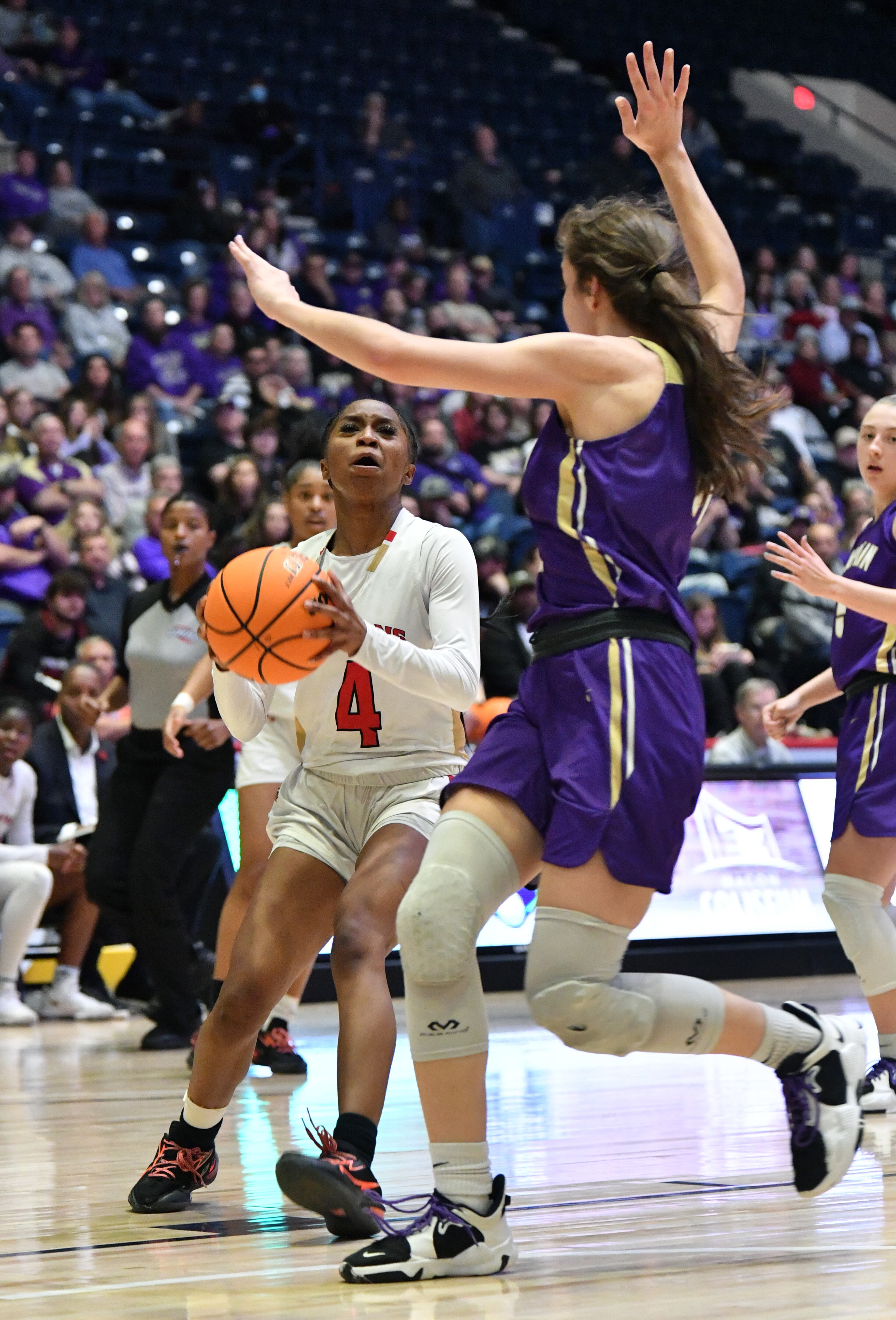March 11, 2022 Macon - Greater Atlanta Christian's Jaci Bolden (4) prepares to shoot against Lumpkin County's Mary Mullinax (11) during the 2022 GHSA State Basketball Class AAA Girls Championship game at the Macon Centreplex in Macon on Friday, March 11, 2022. (Hyosub Shin / Hyosub.Shin@ajc.com)