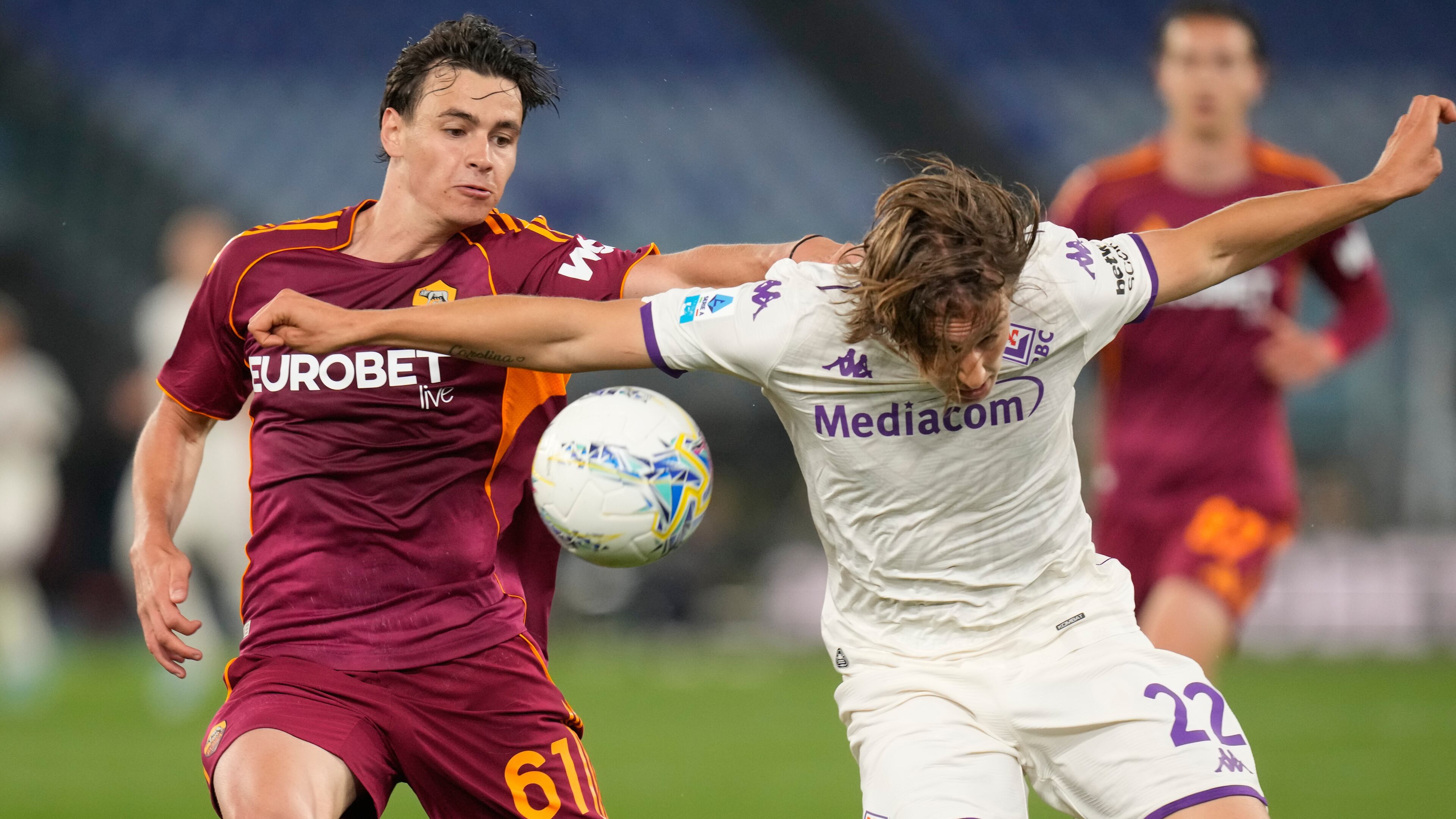 Roma's Niccolo Pisilli, left, challenges for the ball with Fiorentina's Jacopo Fazzini during the Italian Serie A soccer match between Roma and Fiorentina in Rome, Monday, May 4, 2026. (AP Photo/Gregorio Borgia)