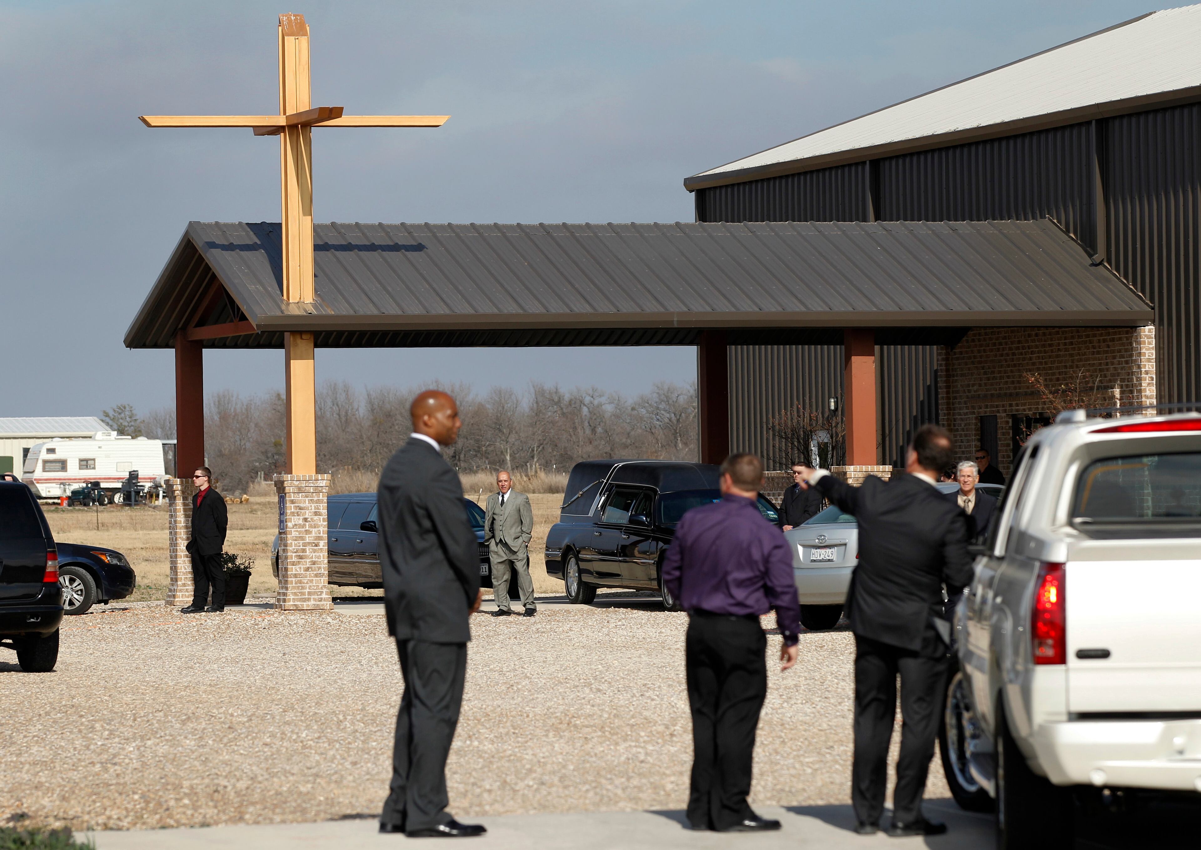 Mourners are directed into the gravel parking lot as they arrive. | More on the service for Perkins | Service held for Belcher