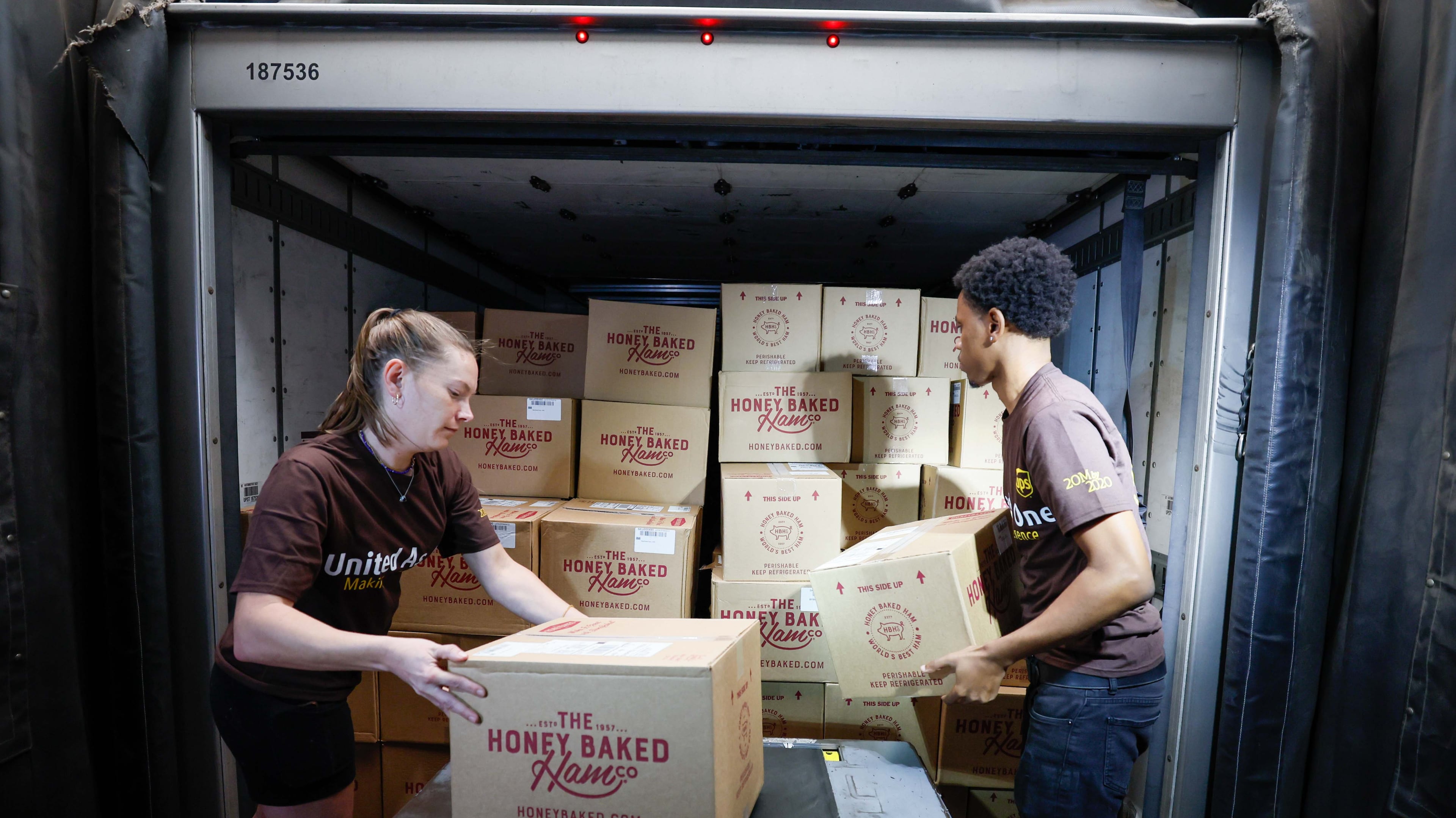 UPS package handlers Courtney Fielding and Kyree Travis unload a truck full of Honey Baked Hams to prepare them for distribution at the UPS S.M.A.R.T Hub on Wednesday, Nov. 20, 2024.
(Miguel Martinez / AJC)