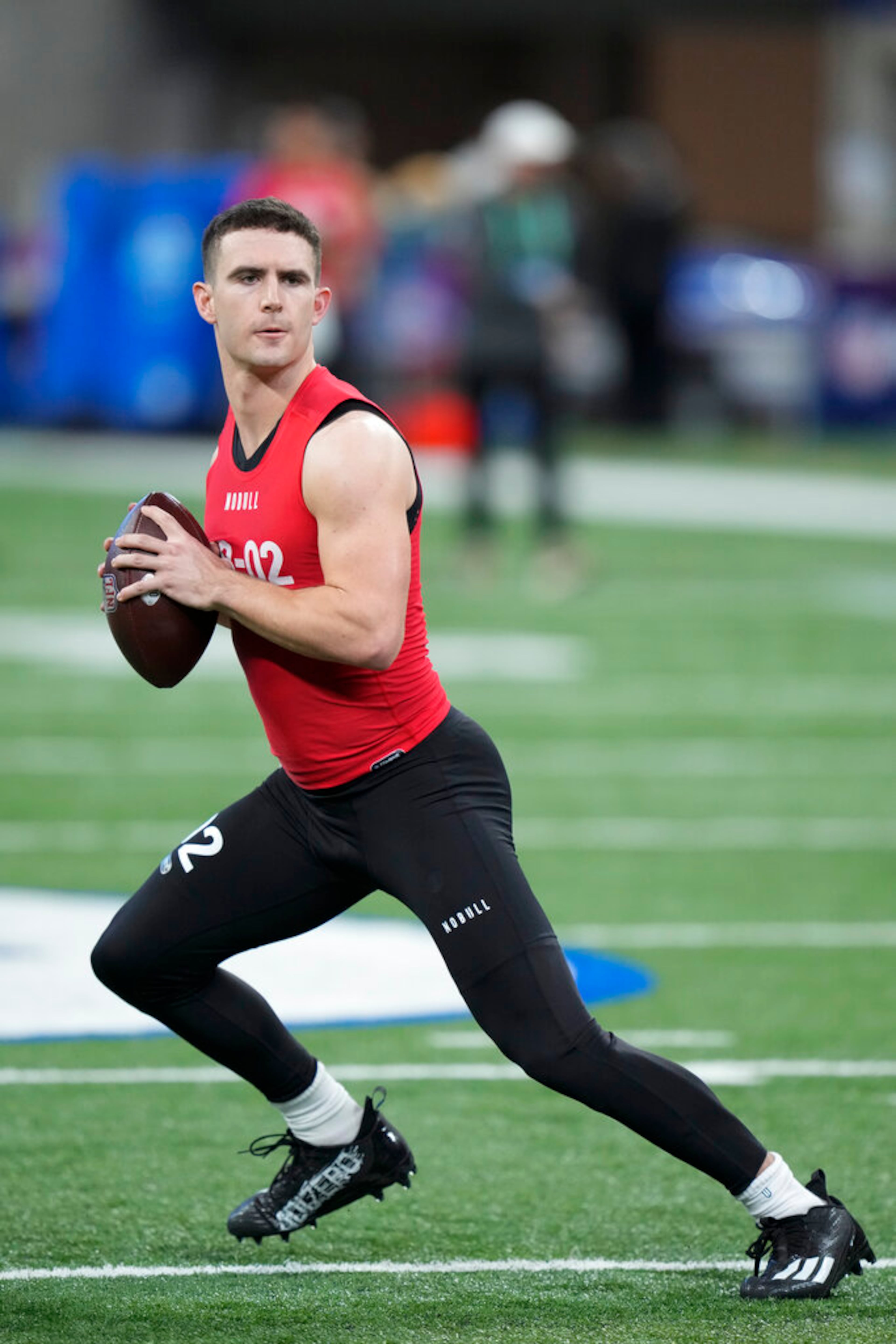 Georgia quarterback Stetson Bennett warms up before he runs a drill at the NFL football scouting combine in Indianapolis, Saturday, March 4, 2023. (AP Photo/Michael Conroy)