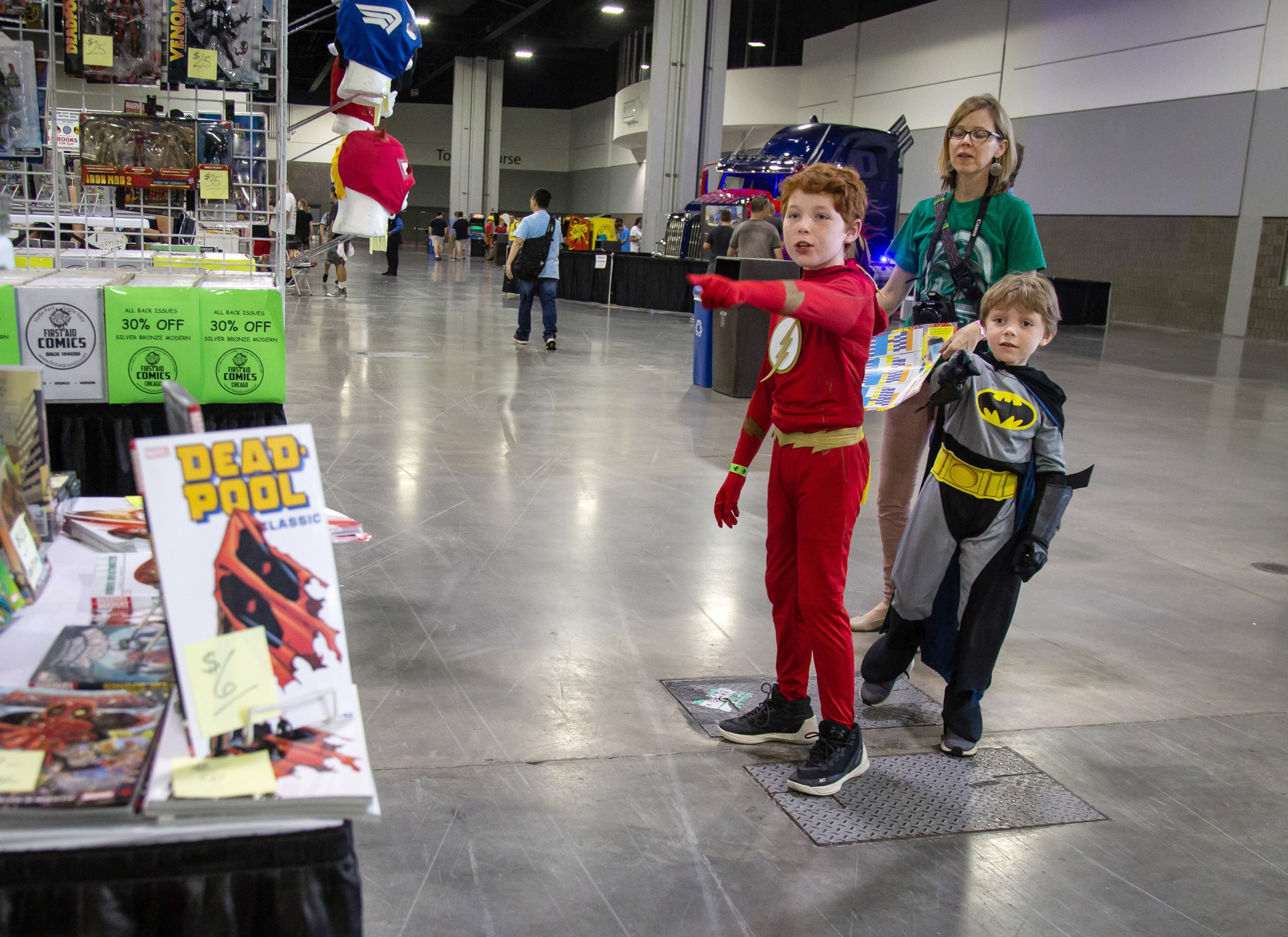 Wilton (L) his brother Lelane (R) and their mother Tracie Dodson try to decide which way to go first after entering the Atlanta Comic Con in the Georgia World Congress Center Sunday, July 2018. STEVE SCHAEFER / SPECIAL TO THE AJC
