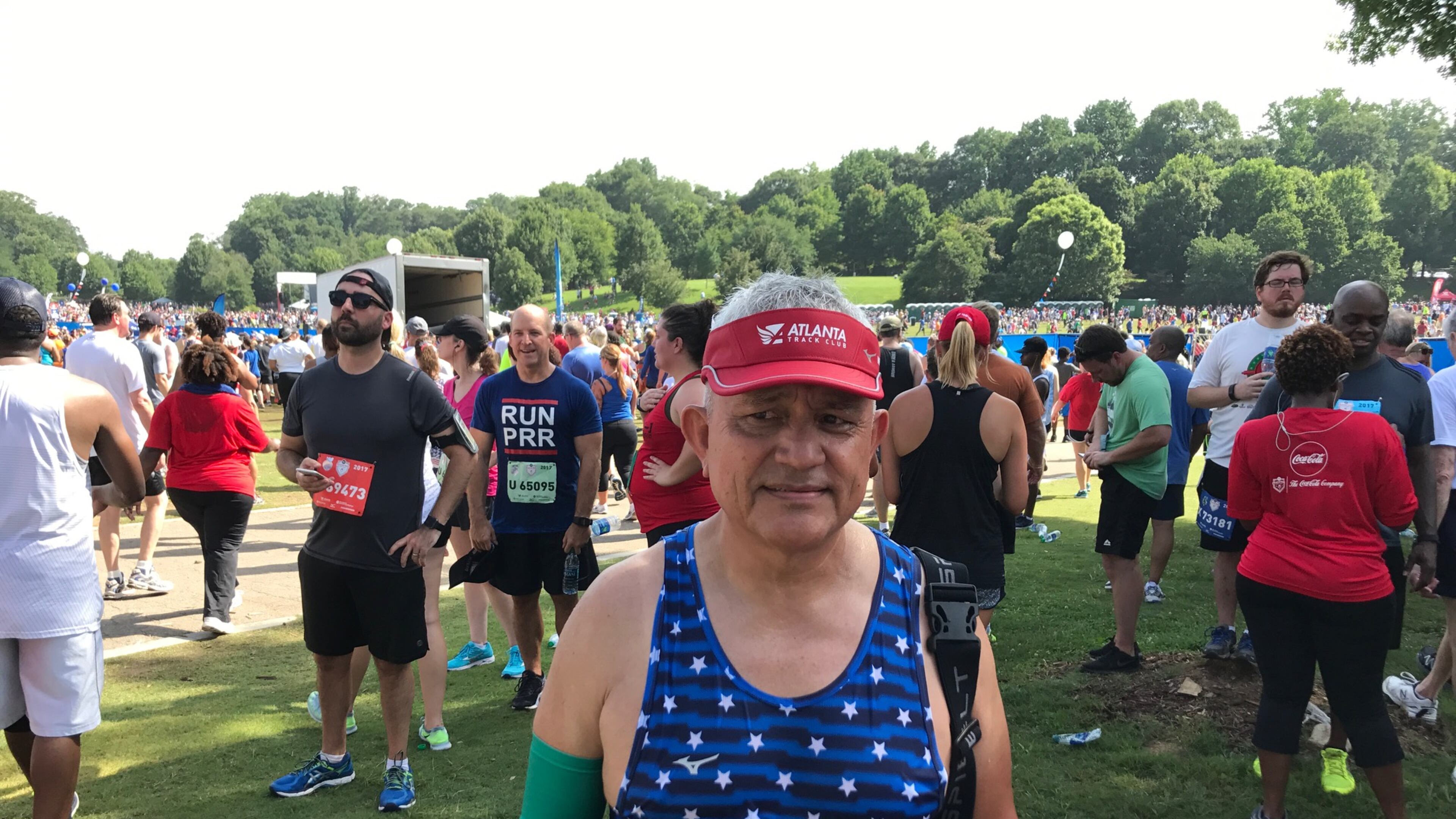 Ricardo Cadillo of Buford stands after finishing his fourth AJC Peachtree Road Race