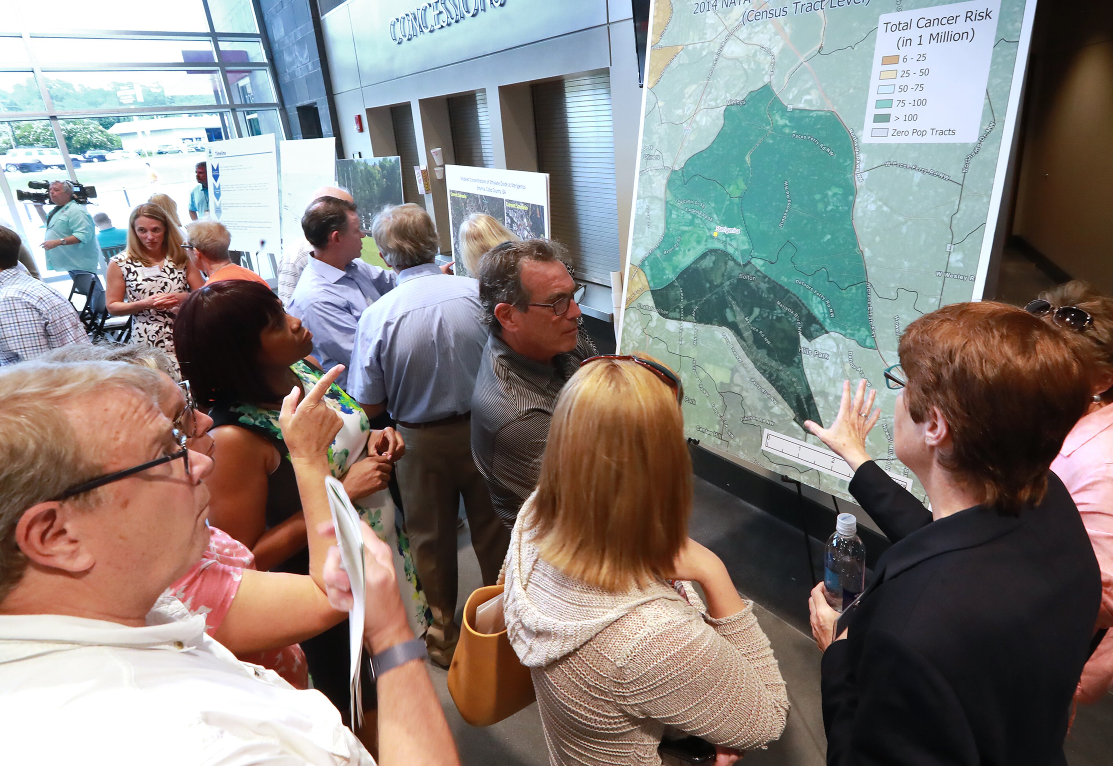 August 19, 2019 Marietta: Concerned area residents crowd around a NATA map of estimated total cancer risk around the Sterigenics site while Cobb officials and environmental regulators hold a town hall and community forum in the wake of reports that Cobb and Fulton have high levels of carcinogenic gas on Monday, August 19, 2019, in Marietta. A user and emitter of the gas, Sterigenics, which sterilizes medical equipment, operates in the area. Curtis Compton/ccompton@ajc.com