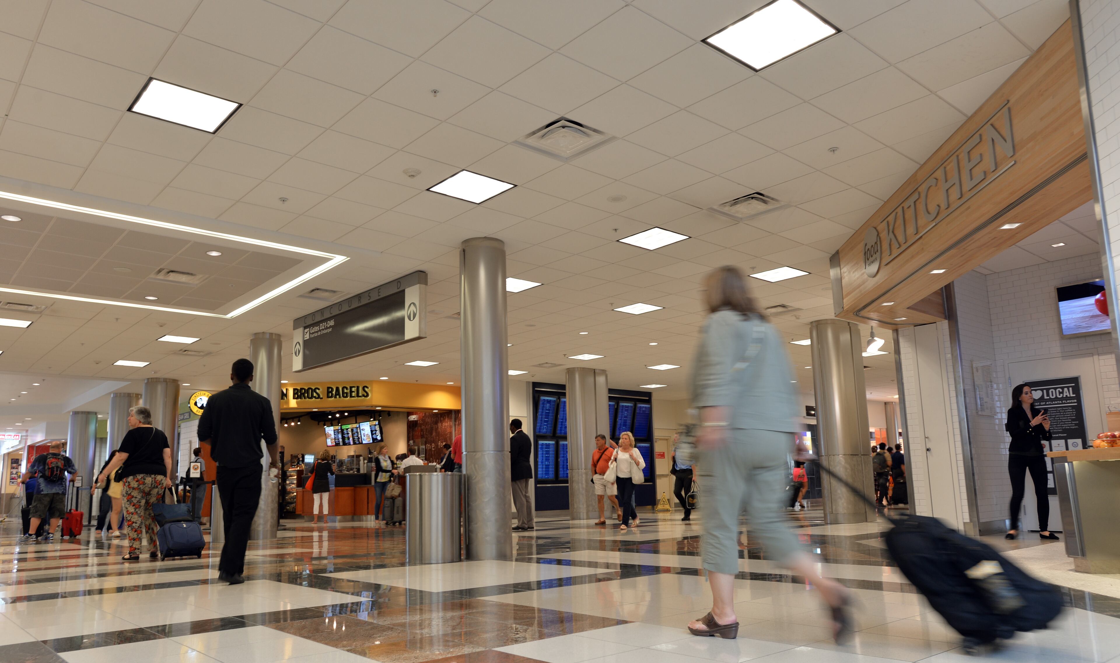 June 24, 2014 Atlanta - Airport travelers walk past one of newest additions, Food Network Kitchen, in Concourse D, Hartsfield-Jackson Atlanta International Airport on Tuesday, June 24, 2014. Hartsfield-Jackson and Delaware North celebrate the newest additions to Concourse D, including local favorites GrindHouse Killer Burgers and Yoforia, and national brands 40/40 Club and Food Network Kitchen. HYOSUB SHIN / HSHIN@AJC.COM