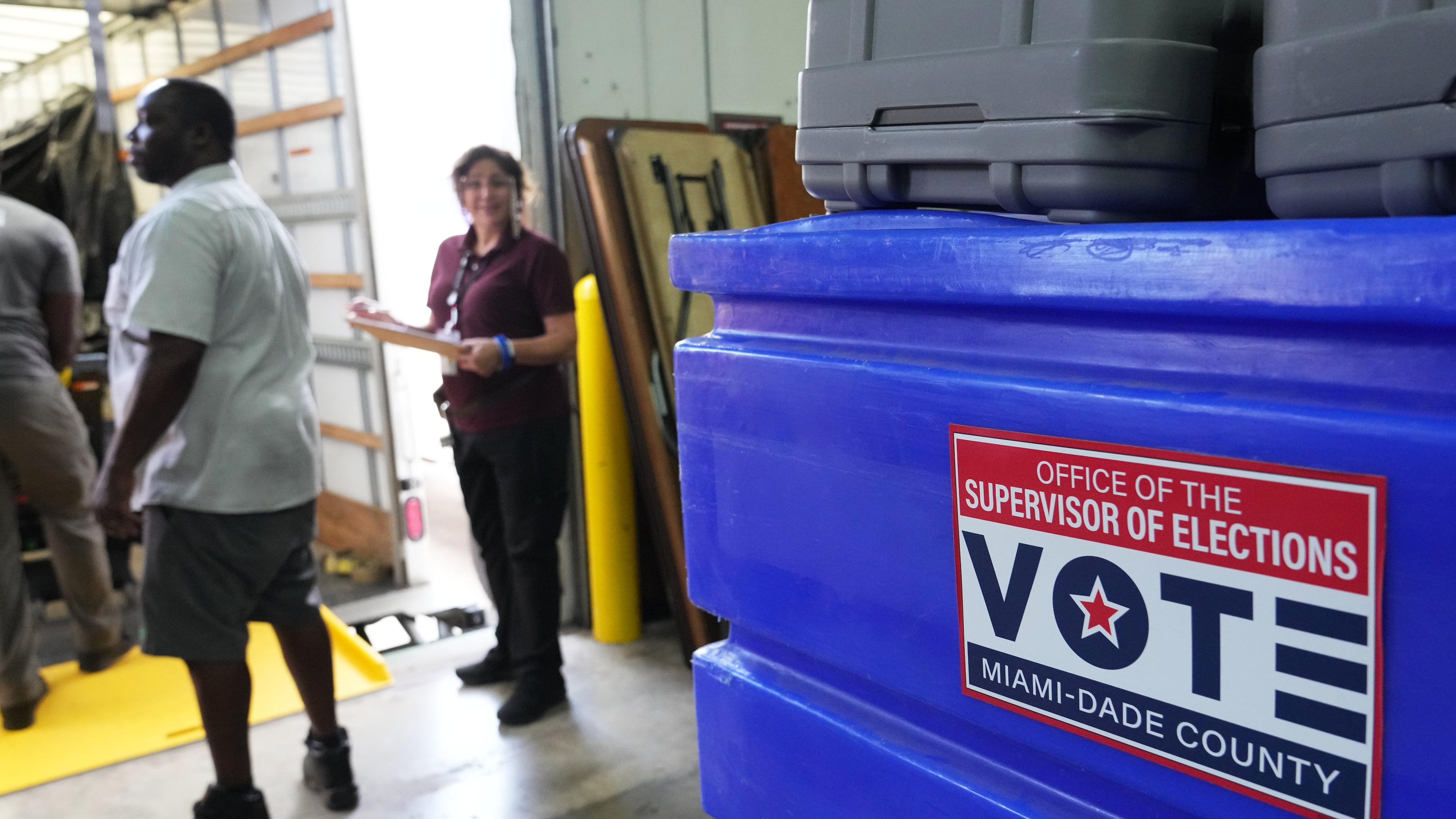 Employees prepare voting equipment at the Miami-Dade Supervisor of Elections Training and Support Center warehouse to be transported to voting precincts in advance of the August 18 Florida primary election, Thursday, Aug. 13, 2026, in Doral, Fla. (AP Photo/Lynne Sladky)