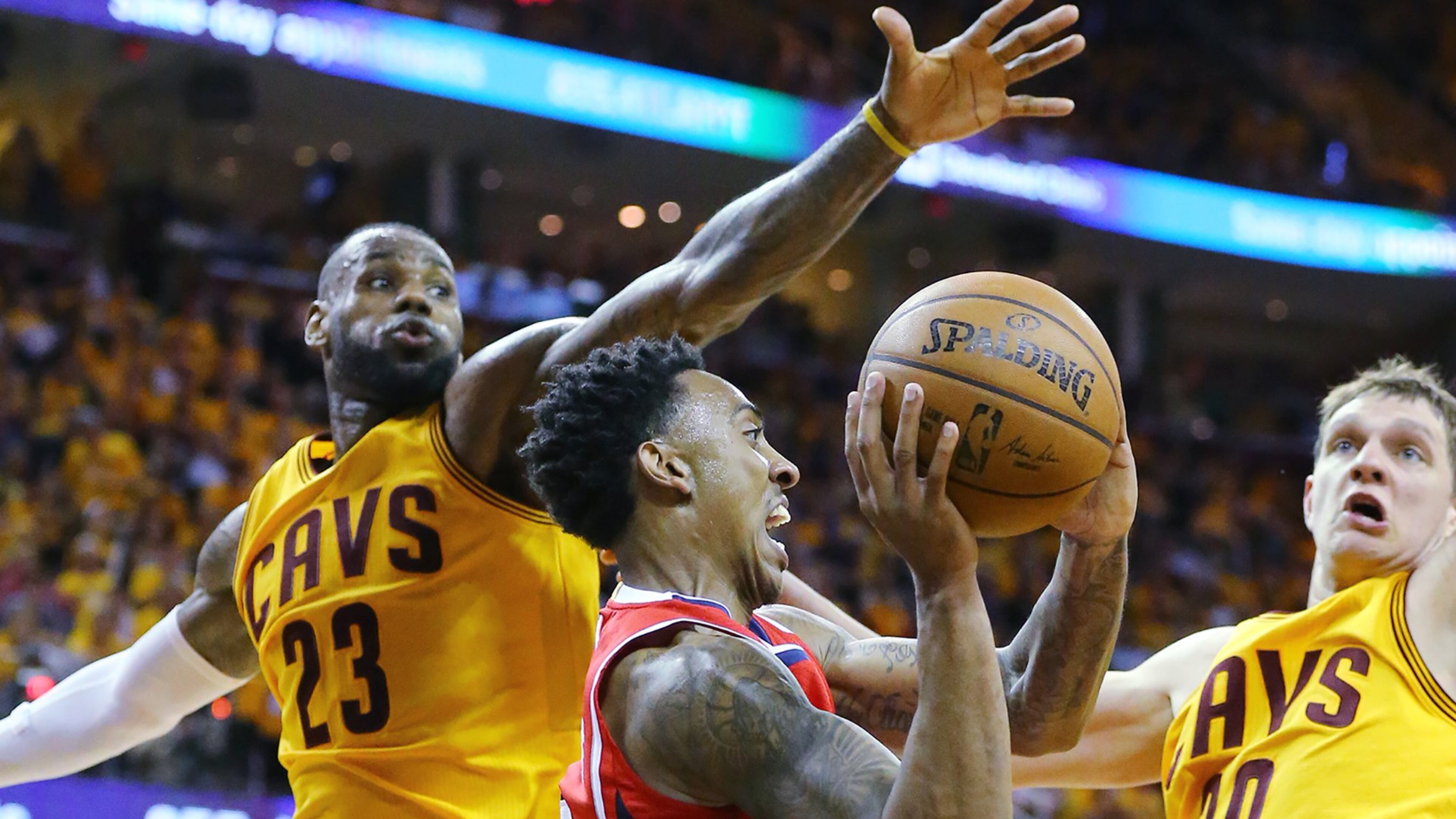 Hawks’ Jeff Teague looks to pass off under the basket drawing a double team from Cavaliers’ LeBron James and Timofey Mozgov in Game 4 of the Eastern Conference Finals on Tuesday, May 26, 2015, in Cleveland. Curtis Compton / ccompton@ajc.com