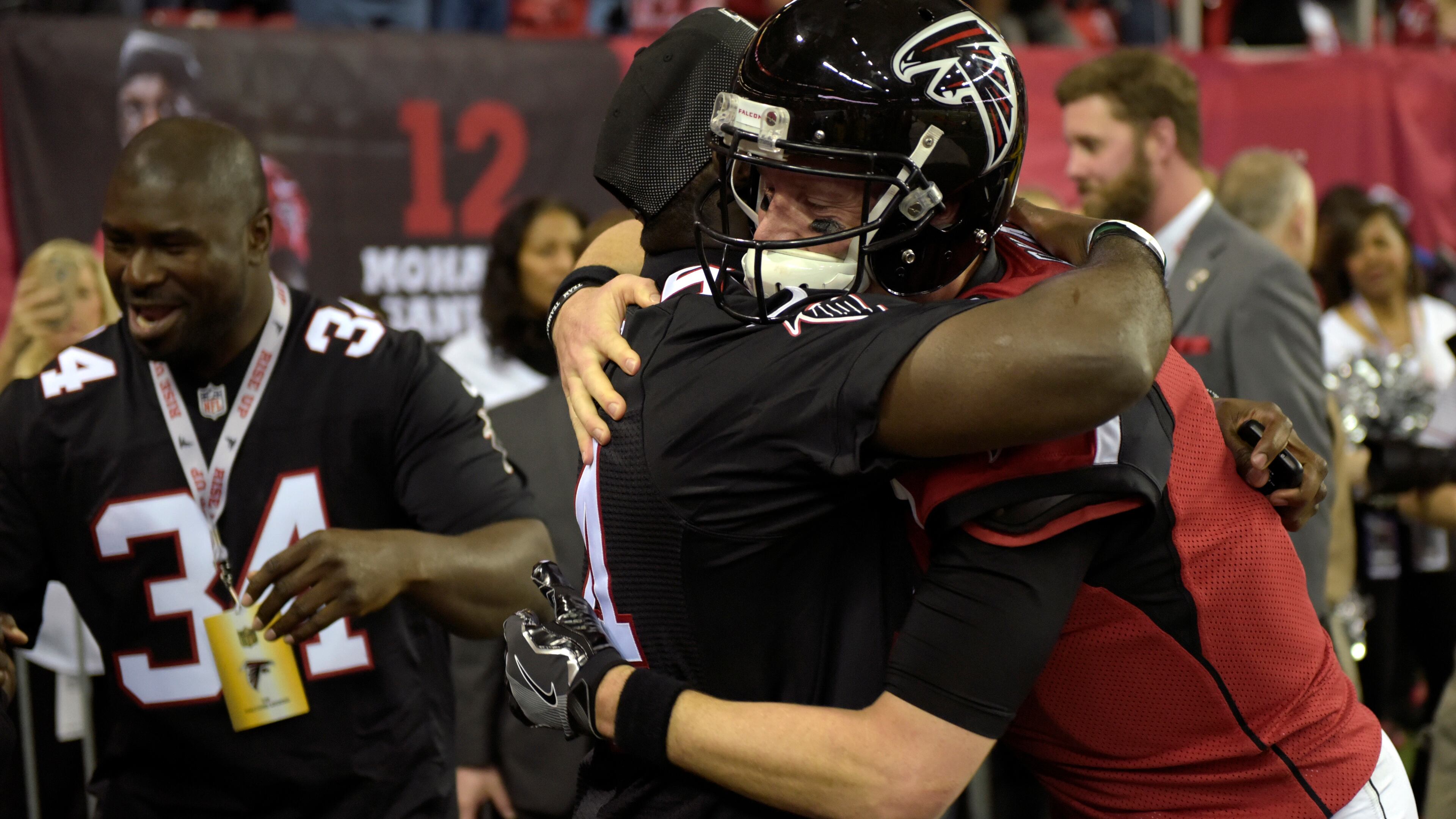 Former Falcons outside linebacker Stephen Nicholas (54) hugs Falcons quarterback Matt Ryan (2) during tribute to Georgia Dome on Sunday, Jan. 1, 2017, in Atlanta.