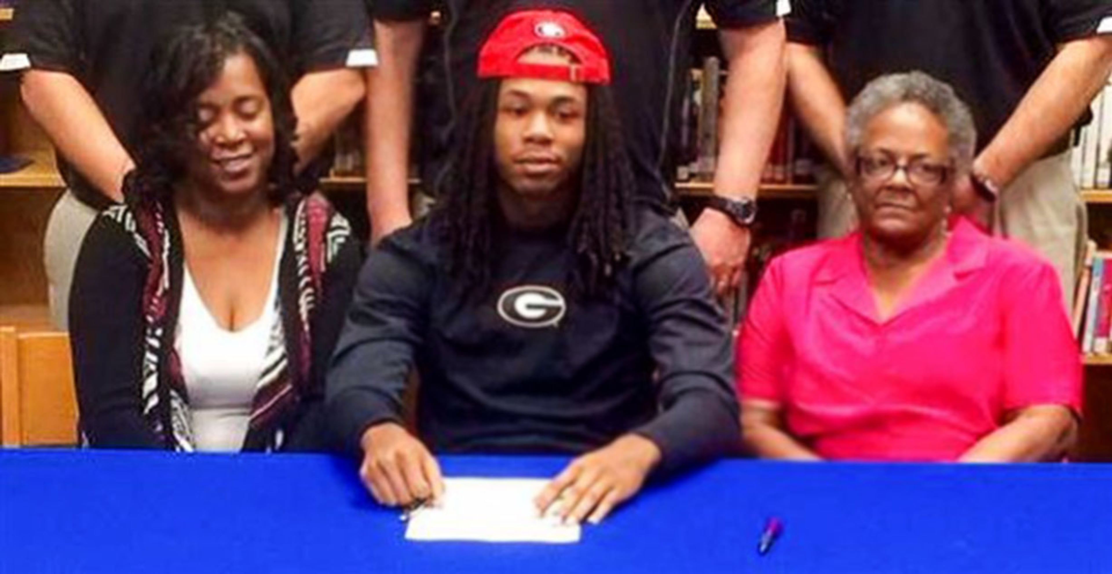 Though he was committed to Clemson for six months and Ohio State once led for his services, Briscoe committed to the Bulldogs on New Year's Day and was the first to send in his signed papers on National Signing Day. Here he is with his mother Jessie (left) and grandmother.