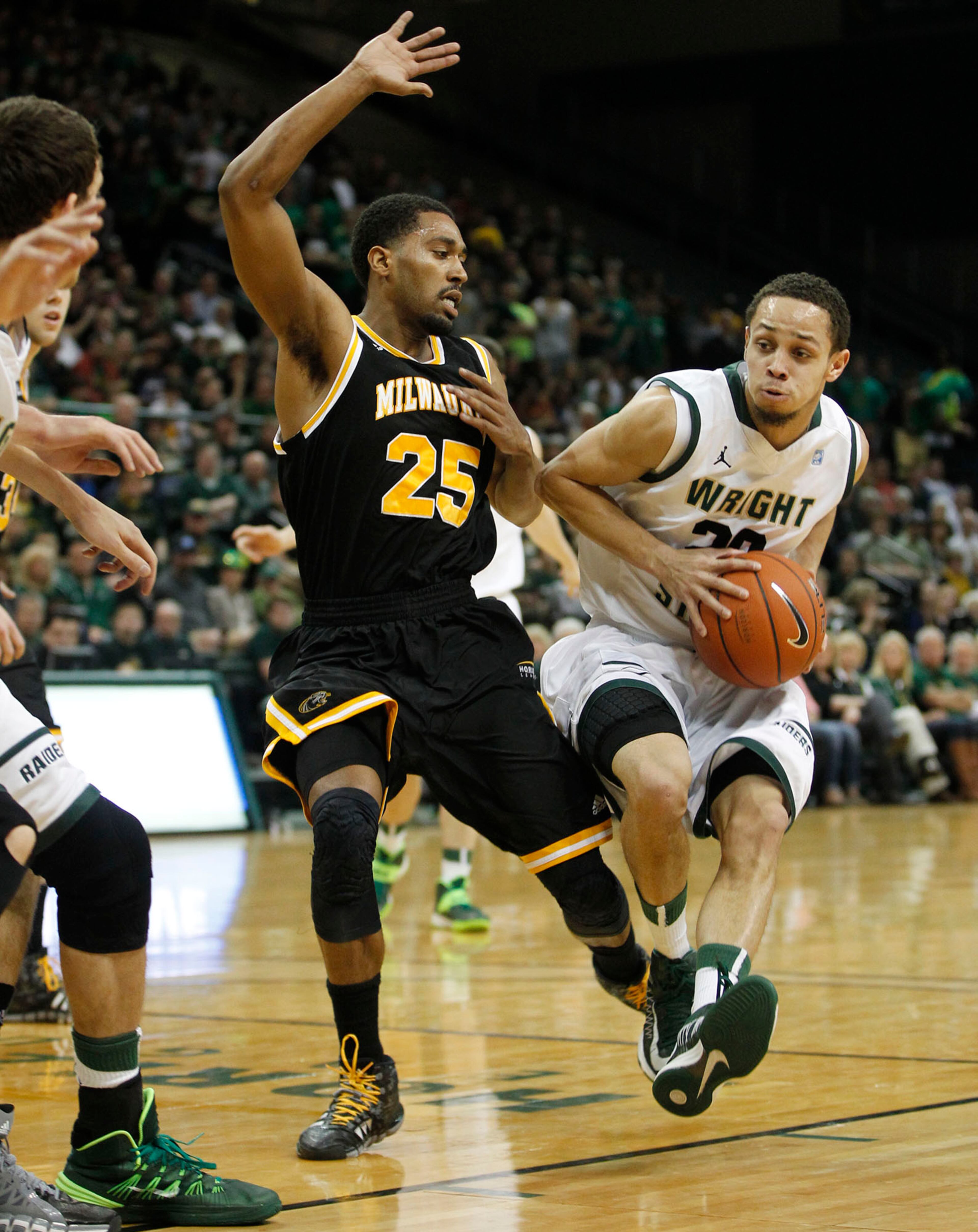 Wright State's Chrishawn Hopkins drives in as the Raiders hosted the Panthers for the Horizon League Championship. TY GREENLEES / STAFF