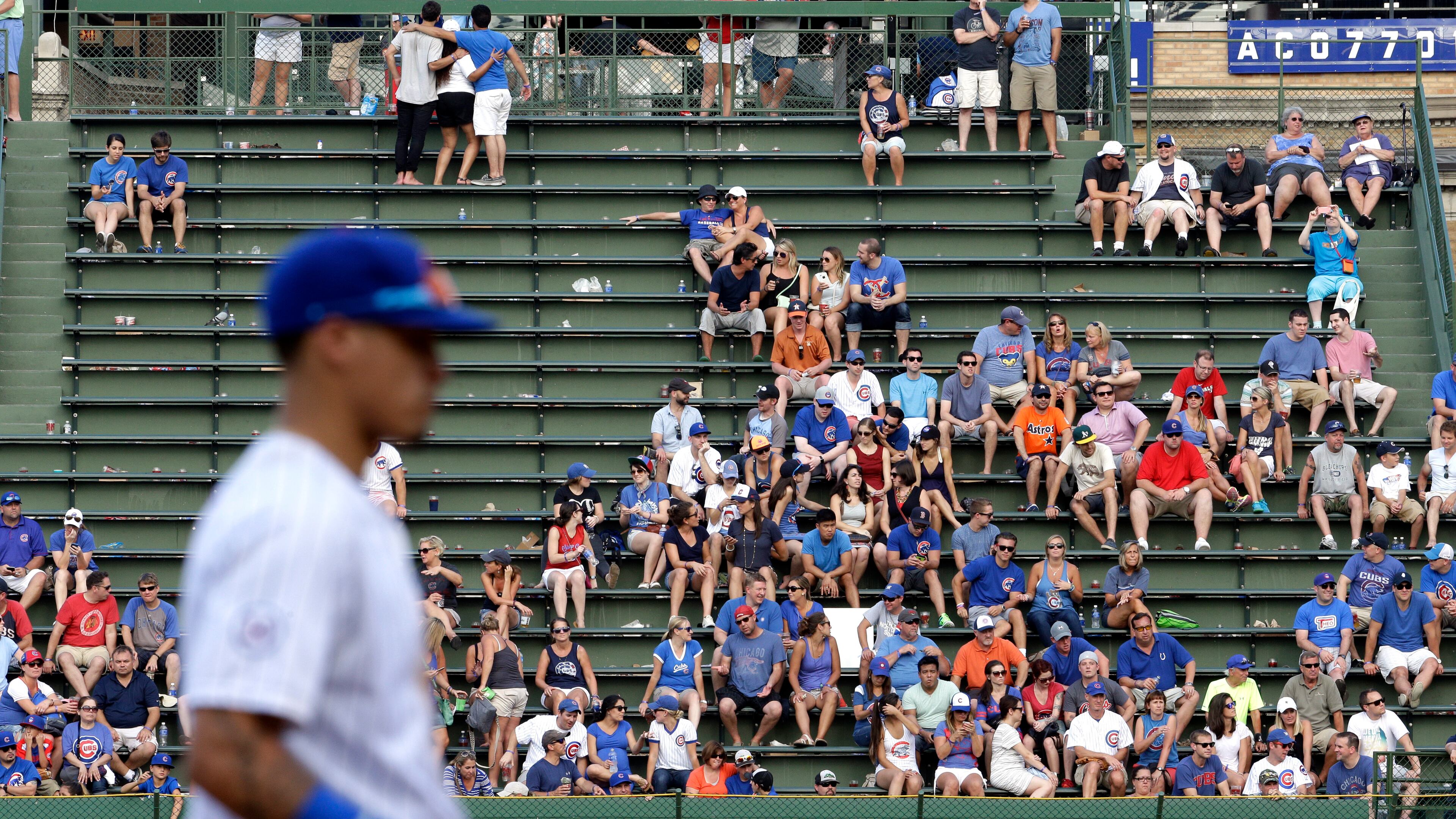 Baseball fans watch a baseball game between the Chicago Cubs and the Arizona Diamondbacks Friday, Sept. 4, 2015, in Chicago. The Cubs won 14-5. (AP Photo/Nam Y. Huh)