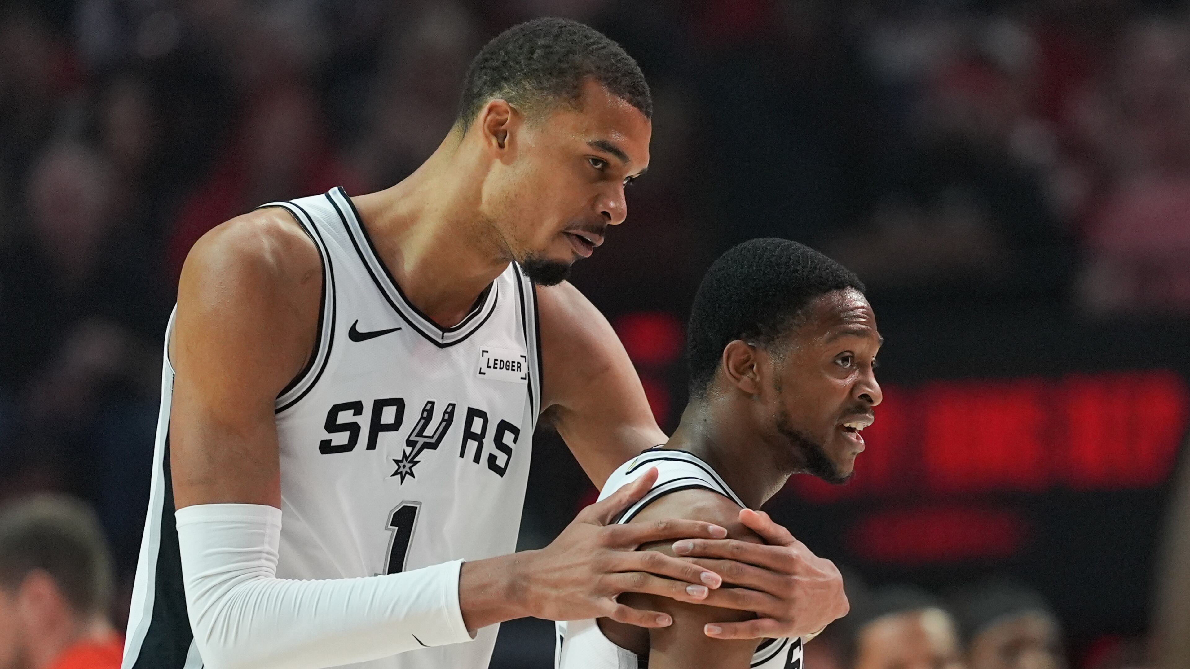 San Antonio Spurs forward/center Victor Wembanyama (1) reacts with guard De'aaron Fox after aplay during the first half in Game 4 of a first-round NBA basketball playoffs series against the Portland Trail Blazers, in Portland, Ore., Sunday, April 26, 2026. (AP Photo/Jenny Kane)