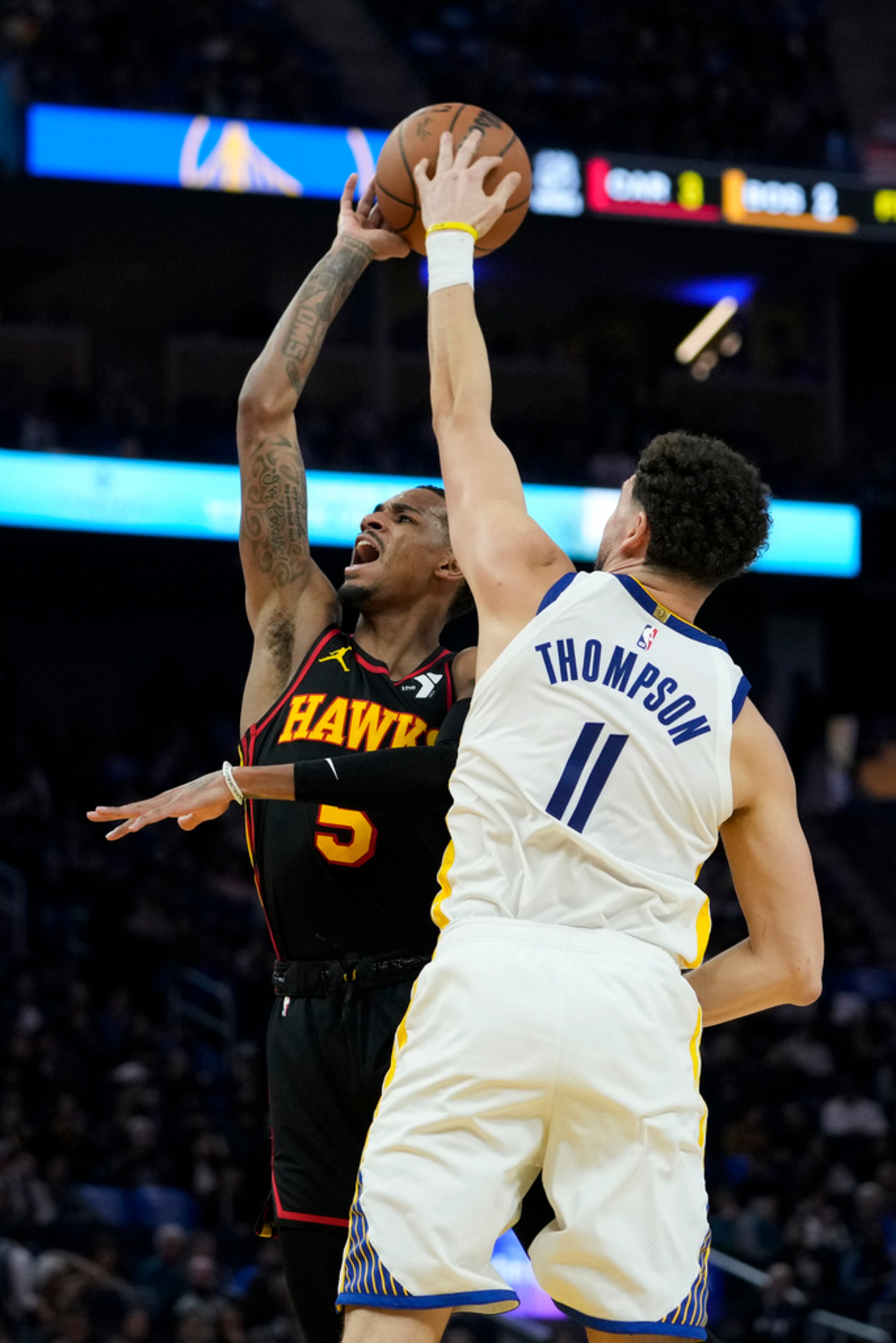 Golden State Warriors guard Klay Thompson (11) blocks a shot by Atlanta Hawks guard Dejounte Murray during the first half of an NBA basketball game, Wednesday, Jan. 24, 2024, in San Francisco. (AP Photo/Godofredo A. Vásquez)