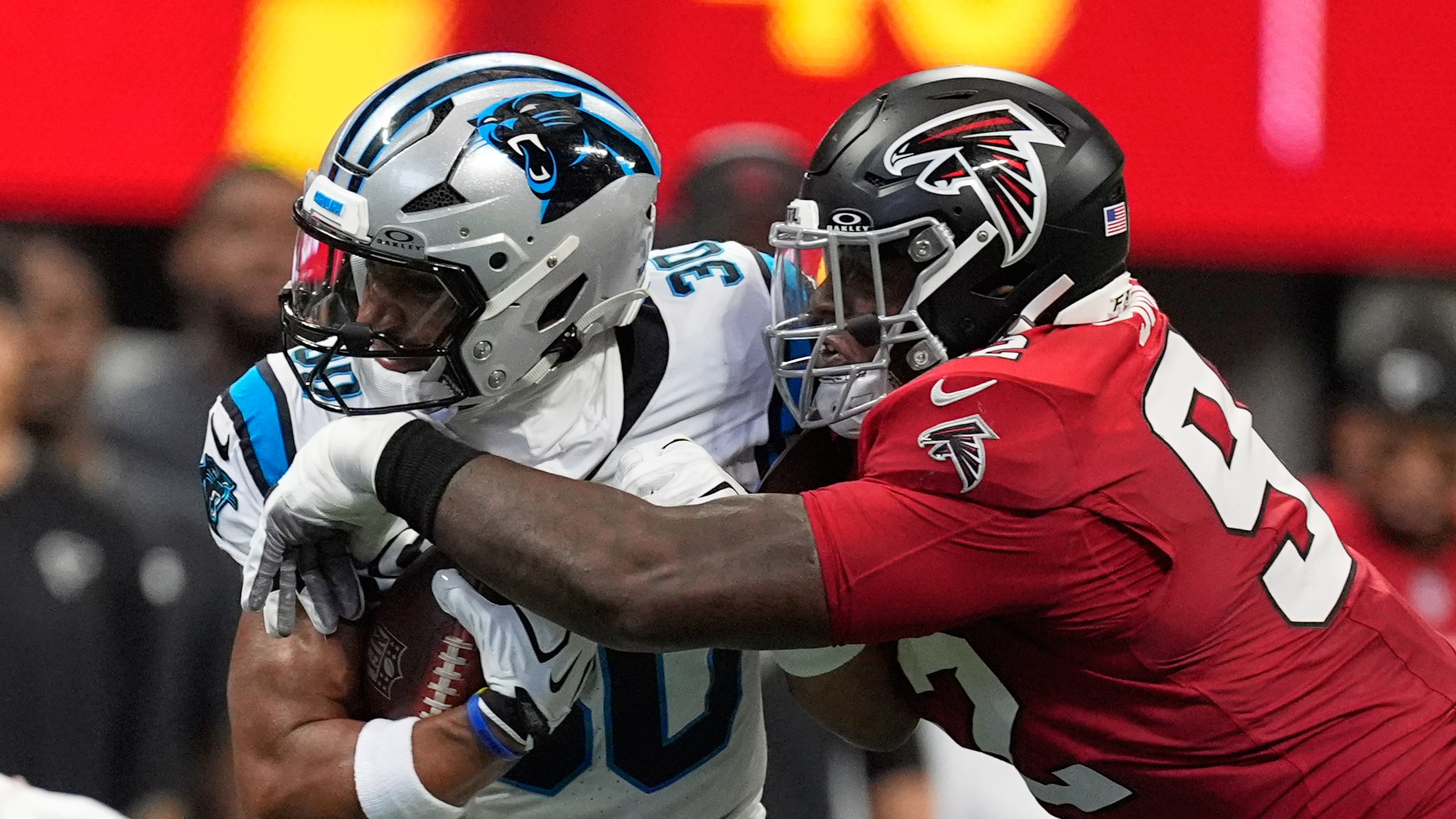 Carolina Panthers running back Chuba Hubbard (left) runs against Atlanta Falcons defensive tackle Maason Smith (right) during an NFL football game in Atlanta, Sunday, Sept. 20, 2026. (Mike Stewart/AP)