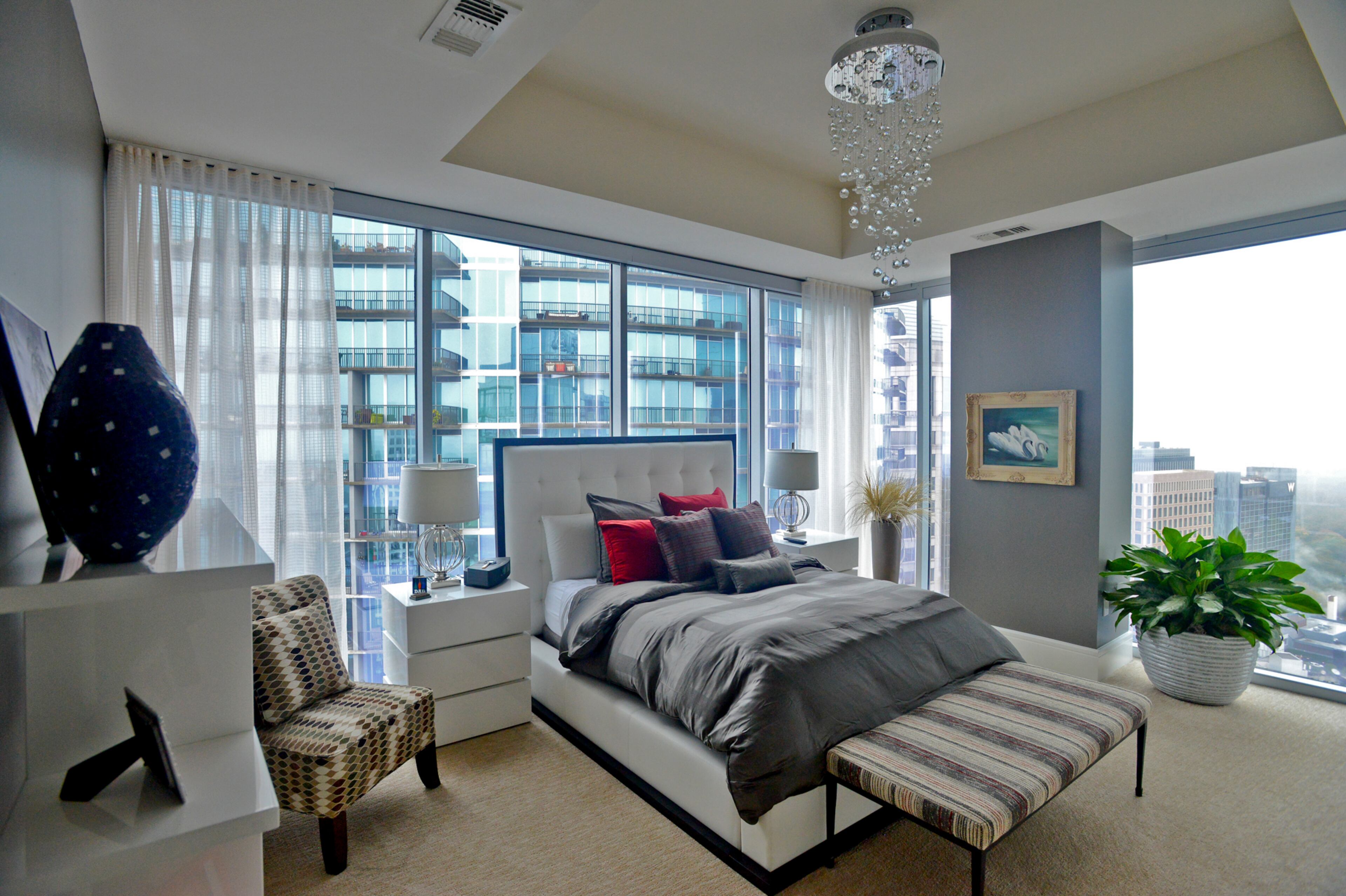 Jim Wilson traded in his traditional Virginia-Highland house for a home in the sky in 2015. The bed with a tufted headboard and sleek side tables are from By Design Furniture, the bench is from Crate & Barrel. The patterned geometric chair is from Rooms To Go and the bedding is from Macy's Hotel Collection.