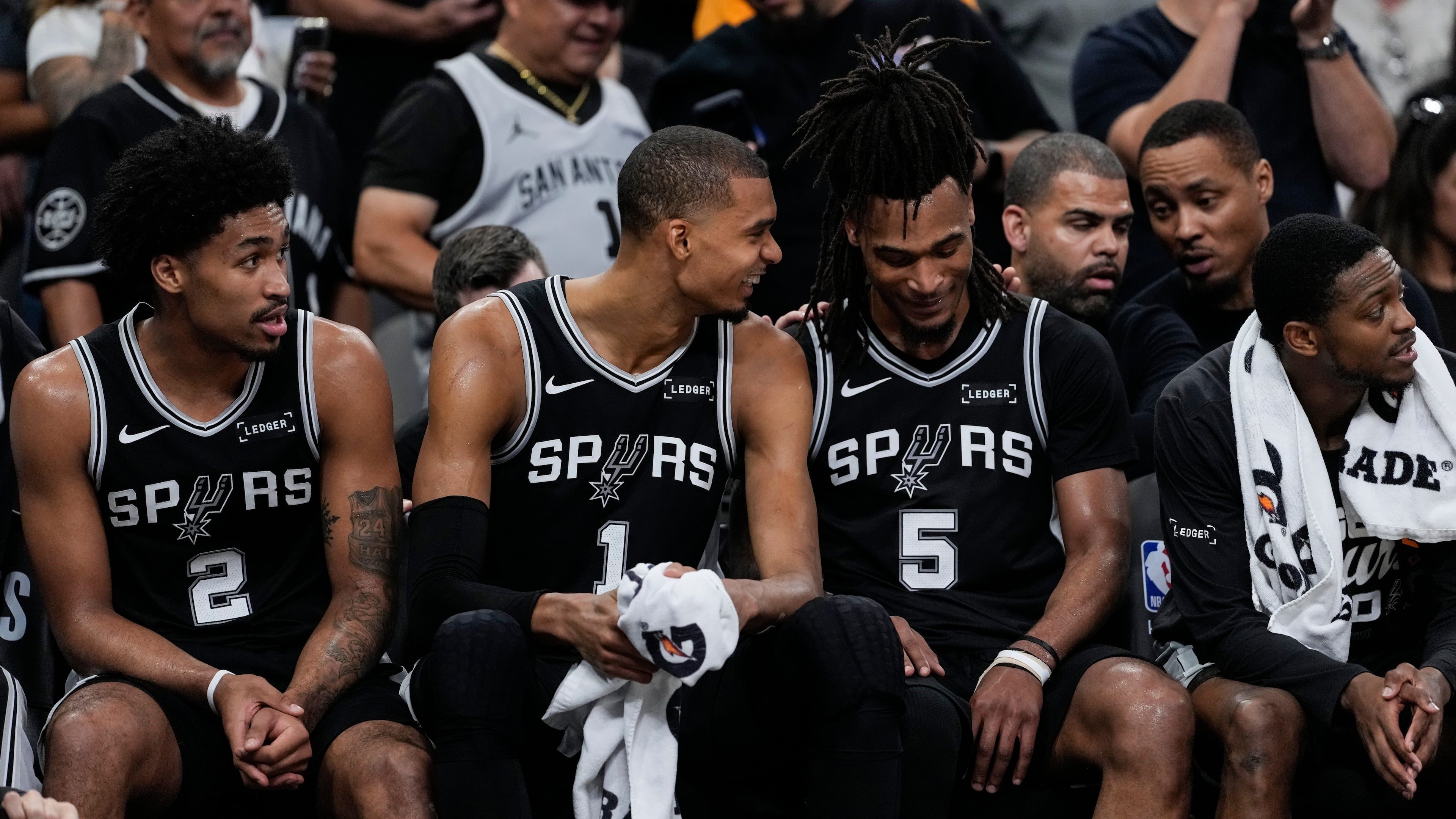 San Antonio Spurs' Victor Wembanyama (1) speaks with Stephon Castle (5) on the bench in the second half of Game 6 in the Western Conference finals NBA basketball playoffs series, Thursday, May 28, 2026, in San Antonio. (AP Photo/David J. Phillip)