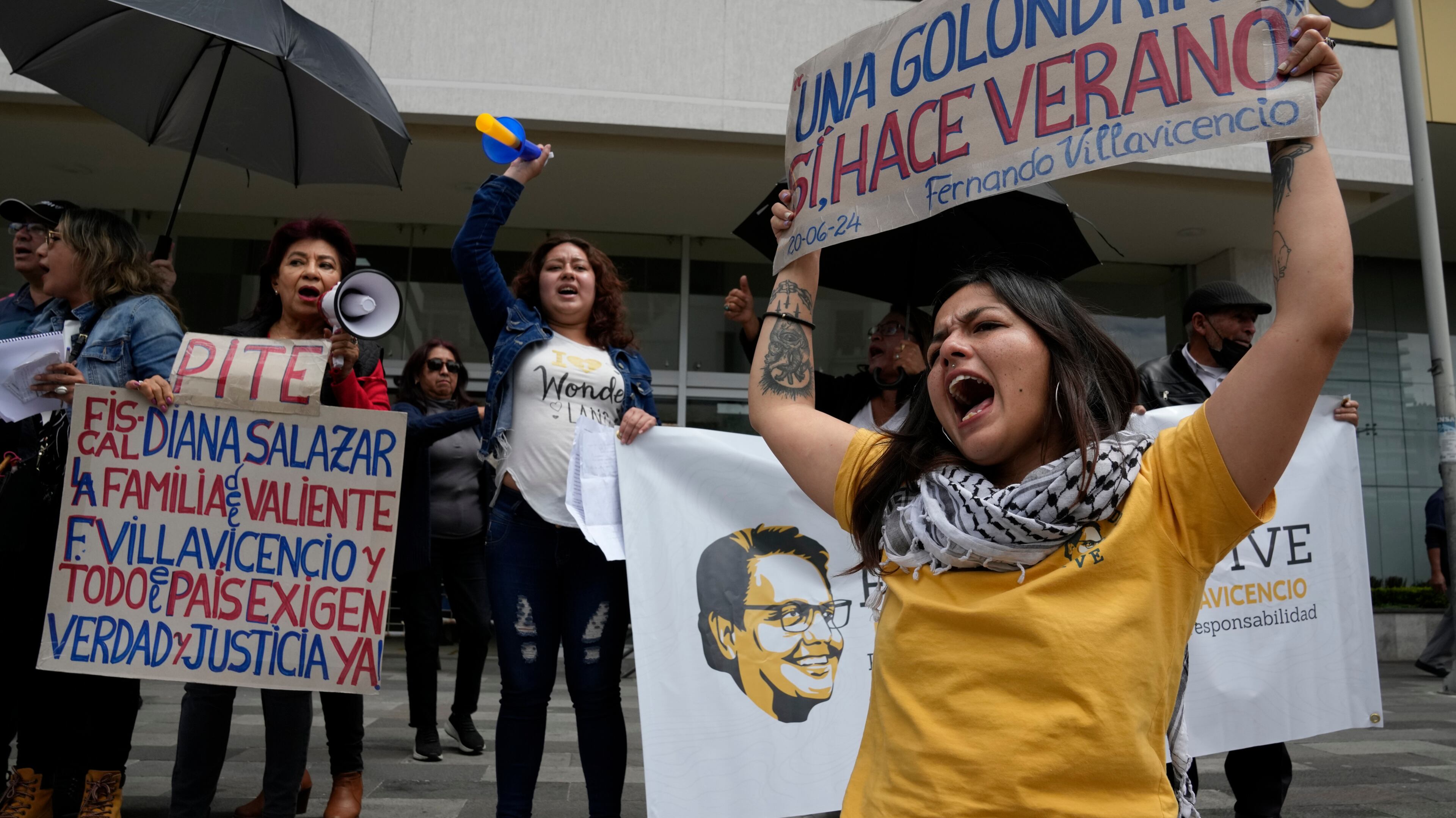 FILE - Amanda Villavicencio, the daughter of murdered presidential candidate Fernando Villavicencio, protests with other members of her family outside the court where suspects in her father's murder are being tried, in Quito, Ecuador, June 27, 2024. (AP Photo/Dolores Ochoa, File)