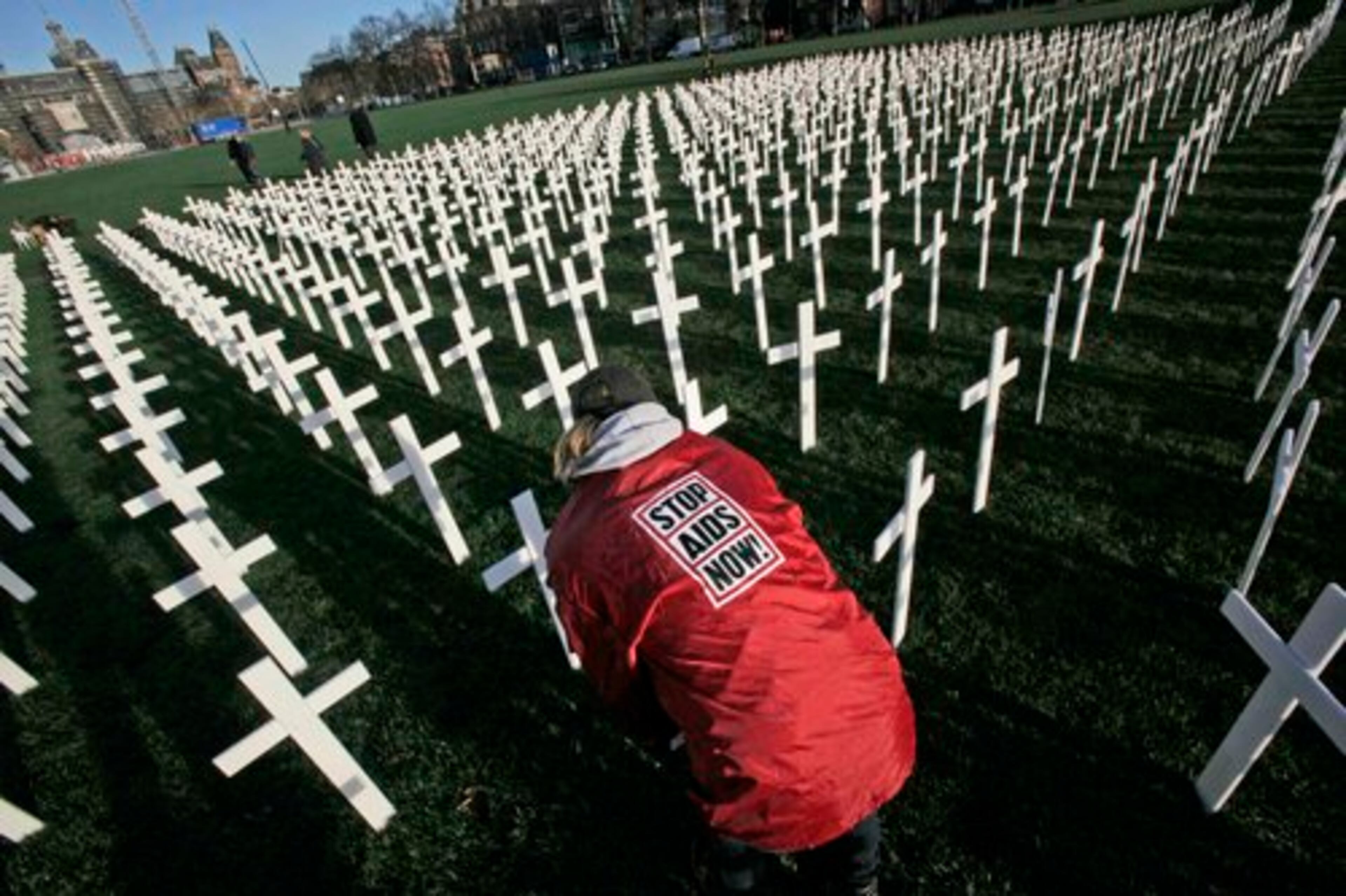 Workers remove the 5,000 crosses which were put on Museum Square to mark World AIDS Day in Amsterdam, Netherlands, Tuesday Dec. 1, 2009. The crosses, planted to look like a cemetery, symbolize the millions of Africans who die of AIDS for lack of access to proper health care and medication.