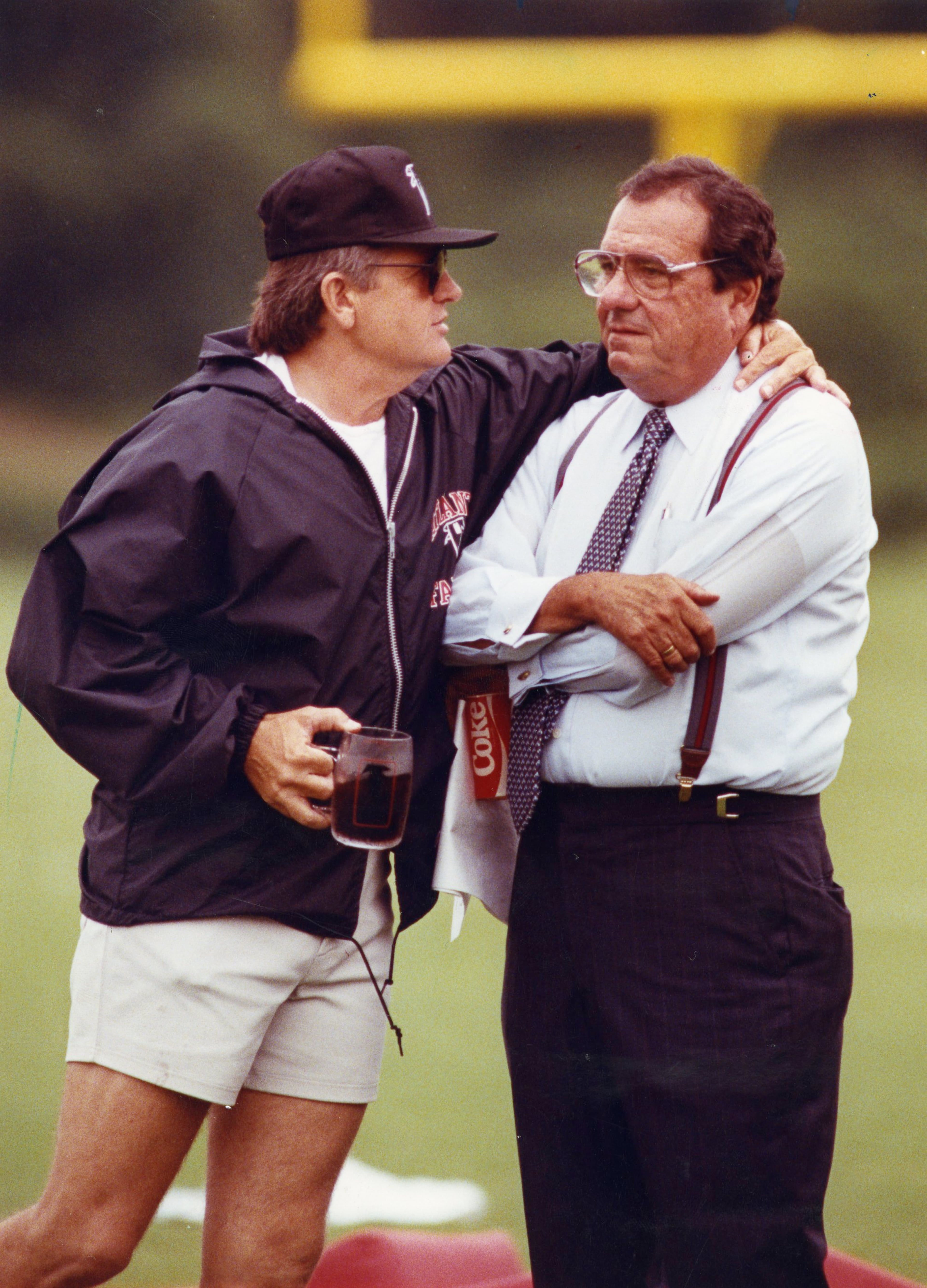 Glanville (left) chats with Falcons owner Rankin Smith at the team's training facility in 1990. AJC file photo