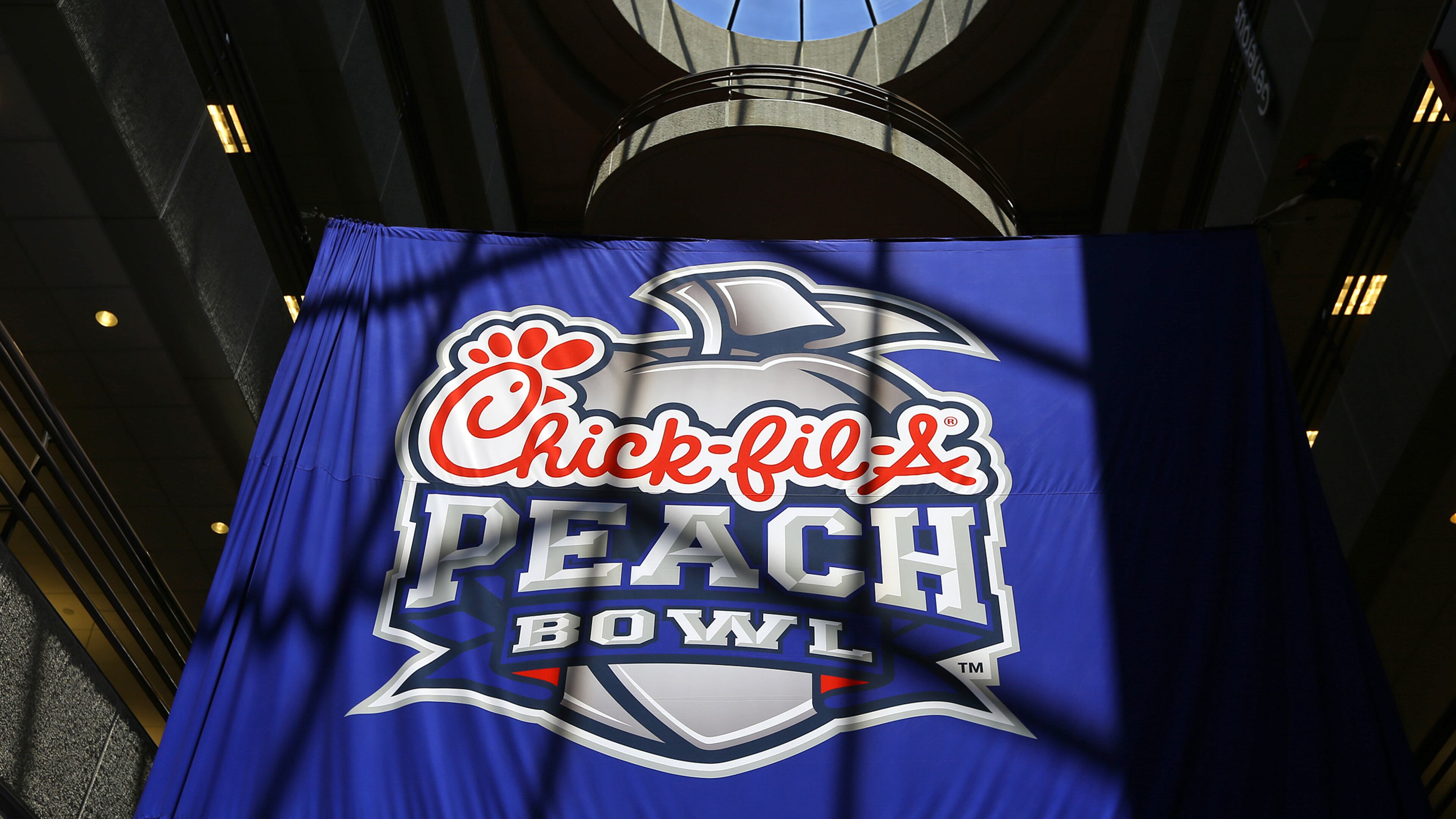 042114 ATLANTA: The new Chick-fil-A Peach Bowl logo hangs in the Chick-fil-A corporate headquarters after an unveiling ceremony on Monday, April 21, 2014, in Atlanta. CURTIS COMPTON / CCOMPTON@AJC.COM