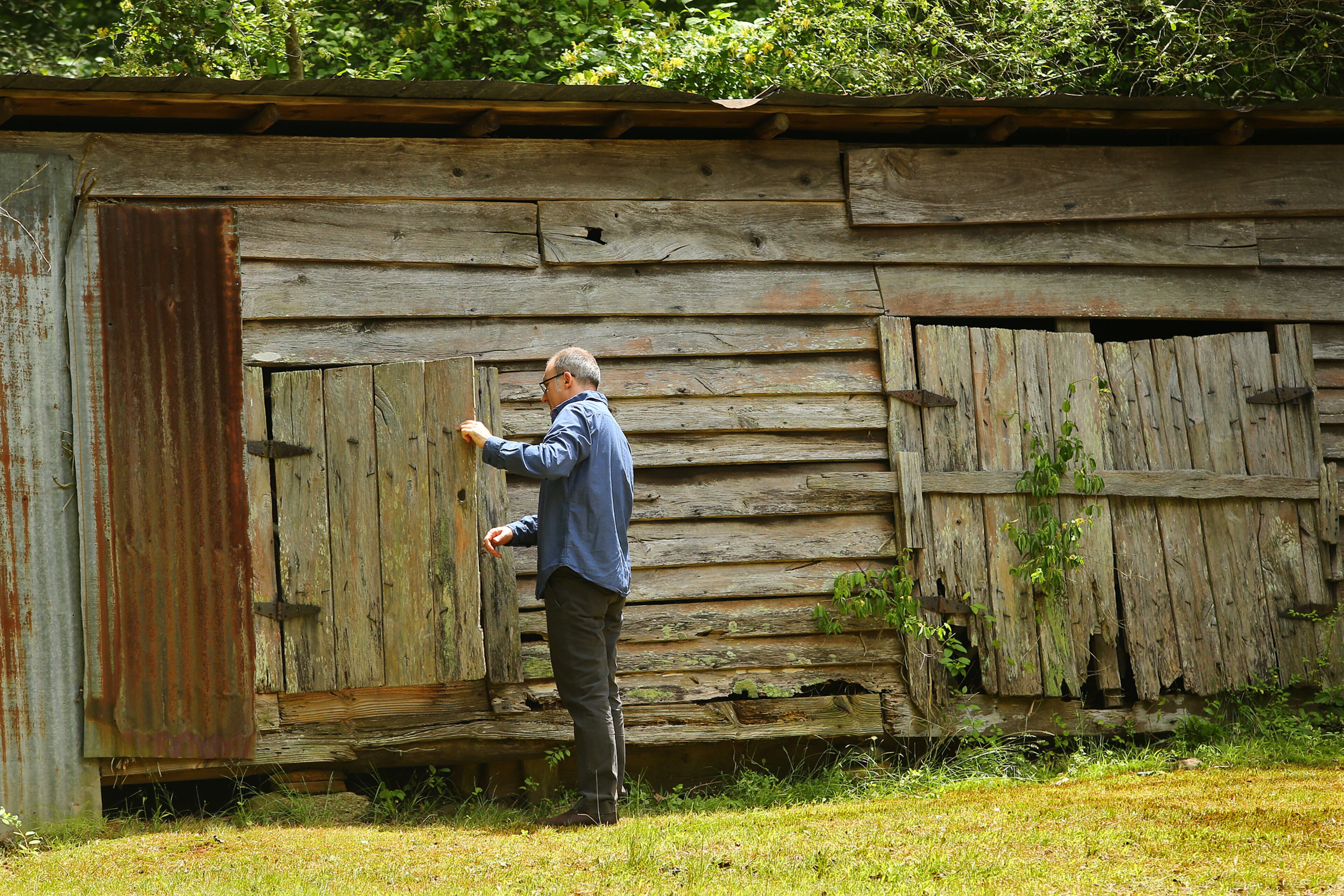 Paul Cooper looks over the grain barn on the 50 acre farm of his grandmother Miss Besse Cooper on Monday, May 19, 2014, in Monroe. Cooper was the oldest person in the world until she died at the age of 116 years and 100 days in 2012. CURTIS COMPTON / CCOMPTON@AJC.COM