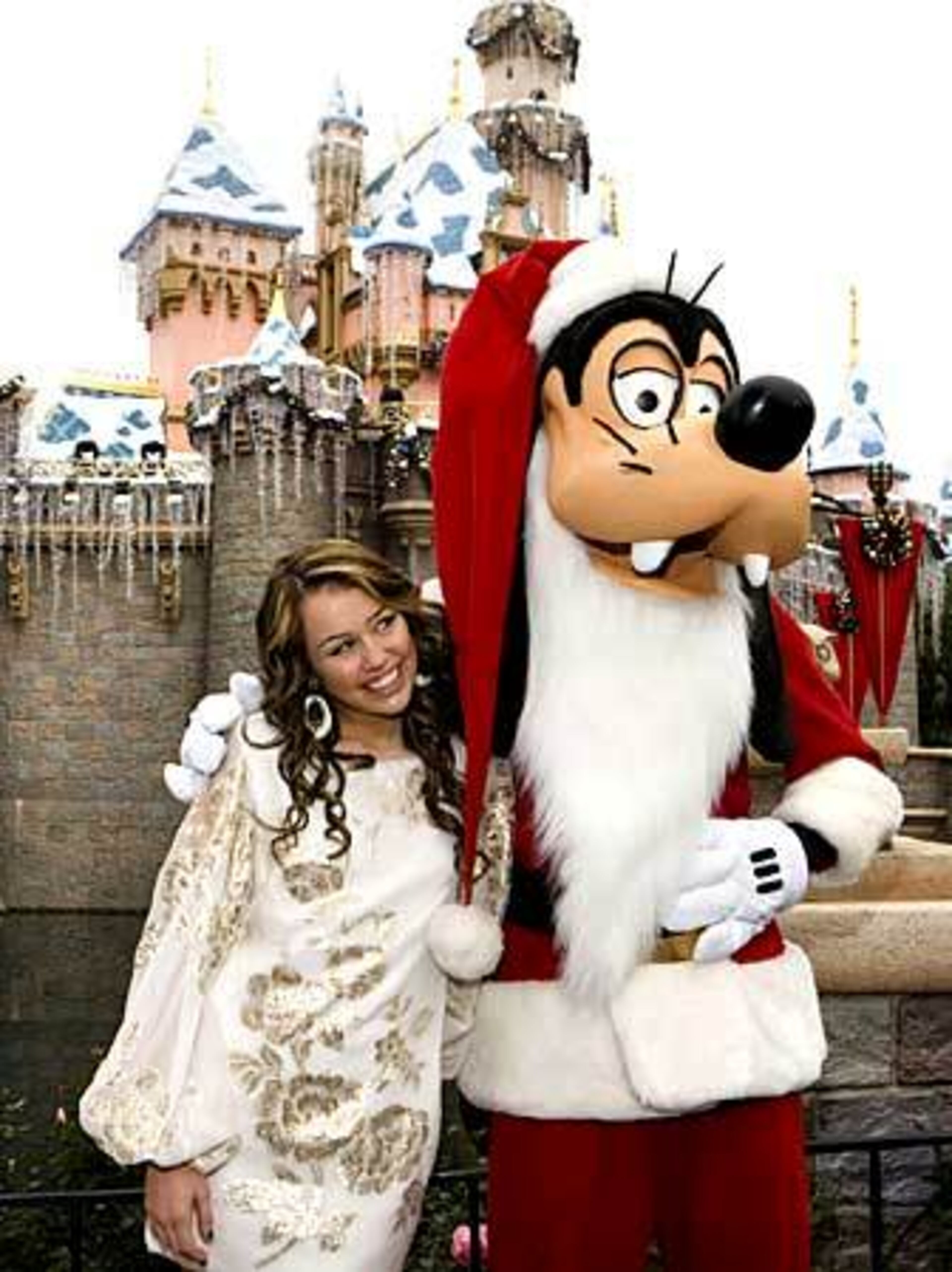 "Hannah Montana" with Goofy during a break from taping a segment for the "Walt Disney World Christmas Day Parade" special at Disneyland in Anaheim, Calif. The special airs Christmas Day on ABC.