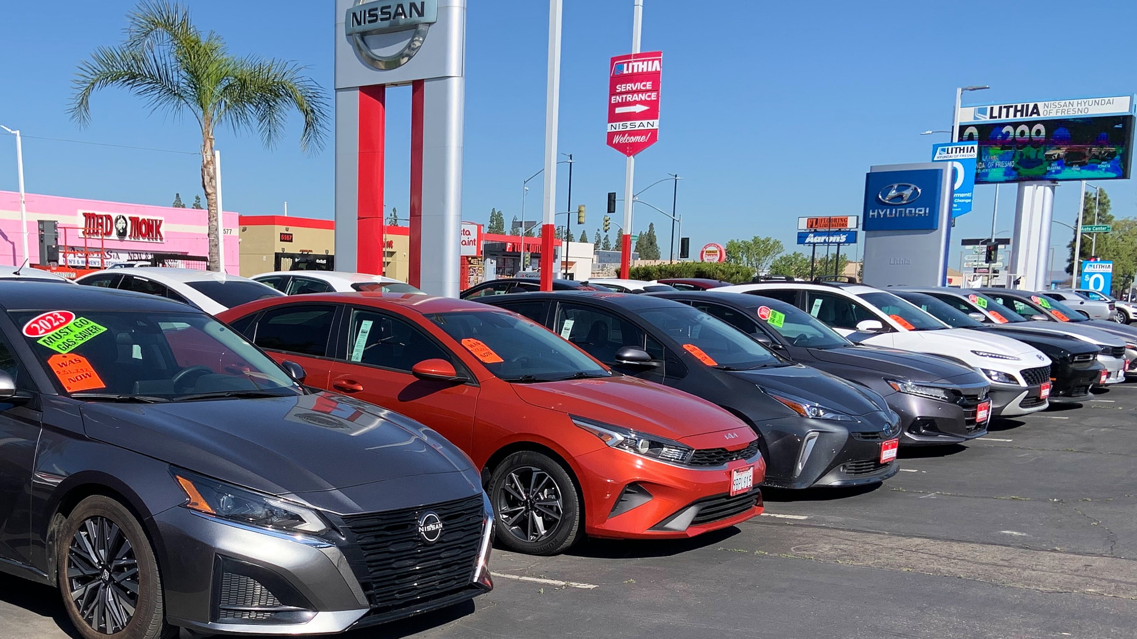 This photo provided by Edmunds shows a lineup of used vehicles at a Nissan dealership in Fresno, Calif. Certified pre-owned vehicles cost more but deliver added peace of mind through inspections by factory-trained technicians, automaker warranties, and more. (Courtesy of Edmunds via AP)