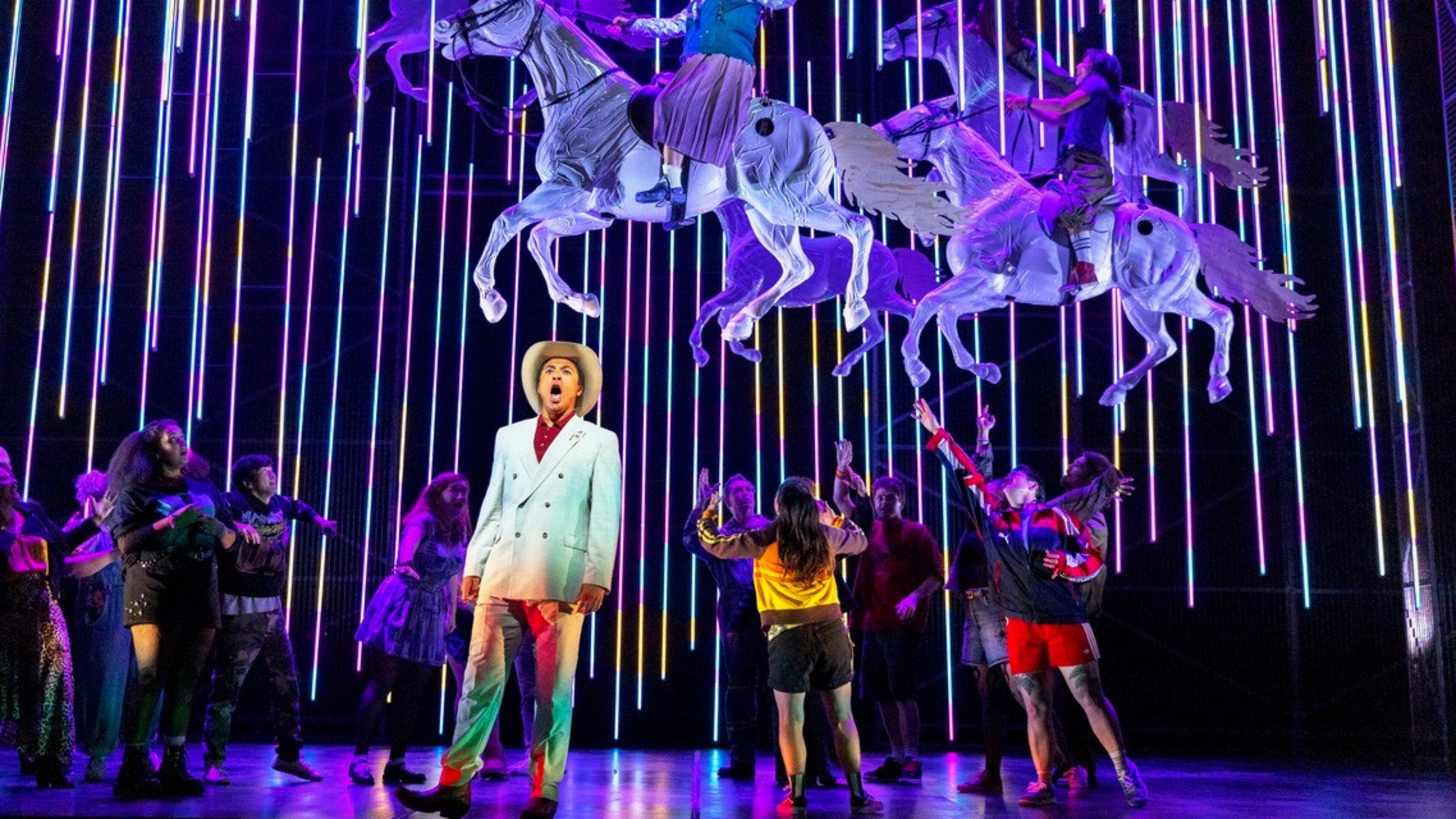 This image released by the Scottish Opera shows Justin Austin, foreground center, and Susan Bullock, top center, during a performance of "The Galloping Cure," at Theatre Royal Glasgow on July 28, 2026 in Glasgow, Scotland. (Antonia Bain/Scottish Opera via AP)