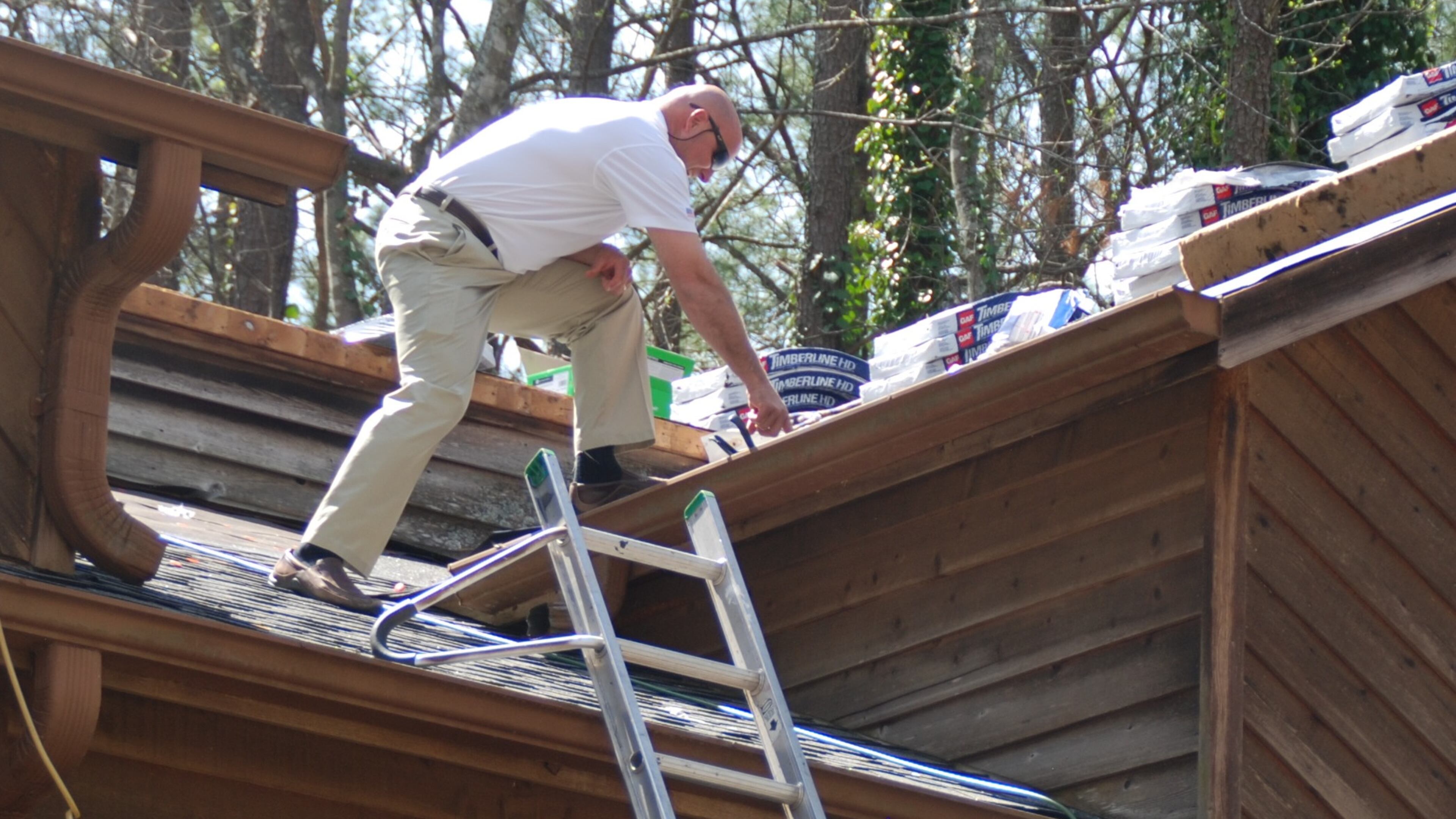 Brent Maddox, who works at GAF, inspects and Terrell and Christy King's roof before North Ridge Roofing begins work on replacing the family's roof. The Kings were the winners of the No Roof Left Behind contest that was held this past January. Photo courtesy of North Ridge Roofing.