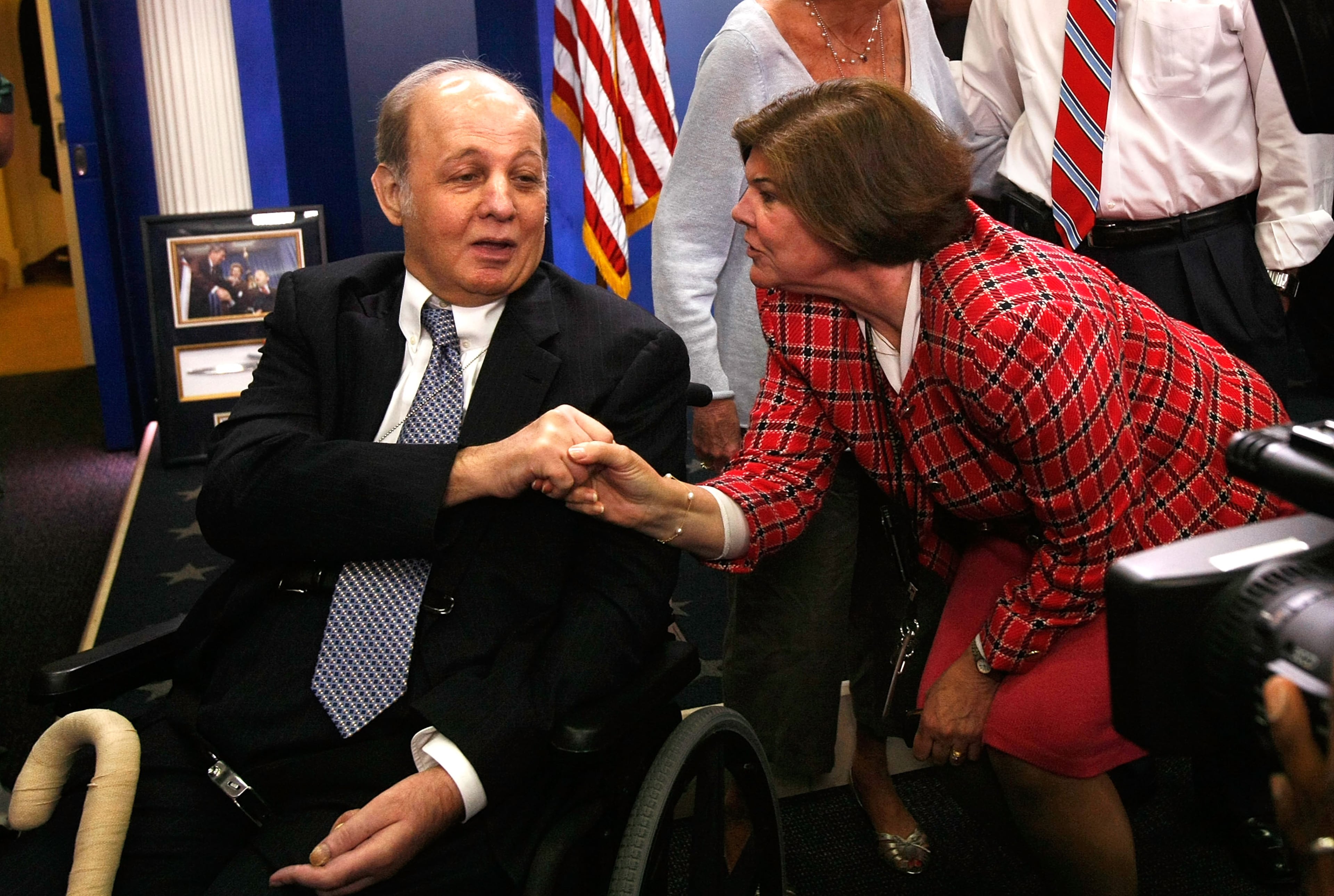 WASHINGTON - JUNE 16: Former White House Press Secretary under the Reagan Administration James Brady (L) is greeted by ABC National Correspondent Ann Comton (R) during his visit to the White House Briefing Room, which named after Brady, June 16, 2009 in Washington, DC. Brady was shot in the head and became permanently disabled during the assassination attempt on former president Ronald Reagan in 1981. (Photo by Alex Wong/Getty Images)