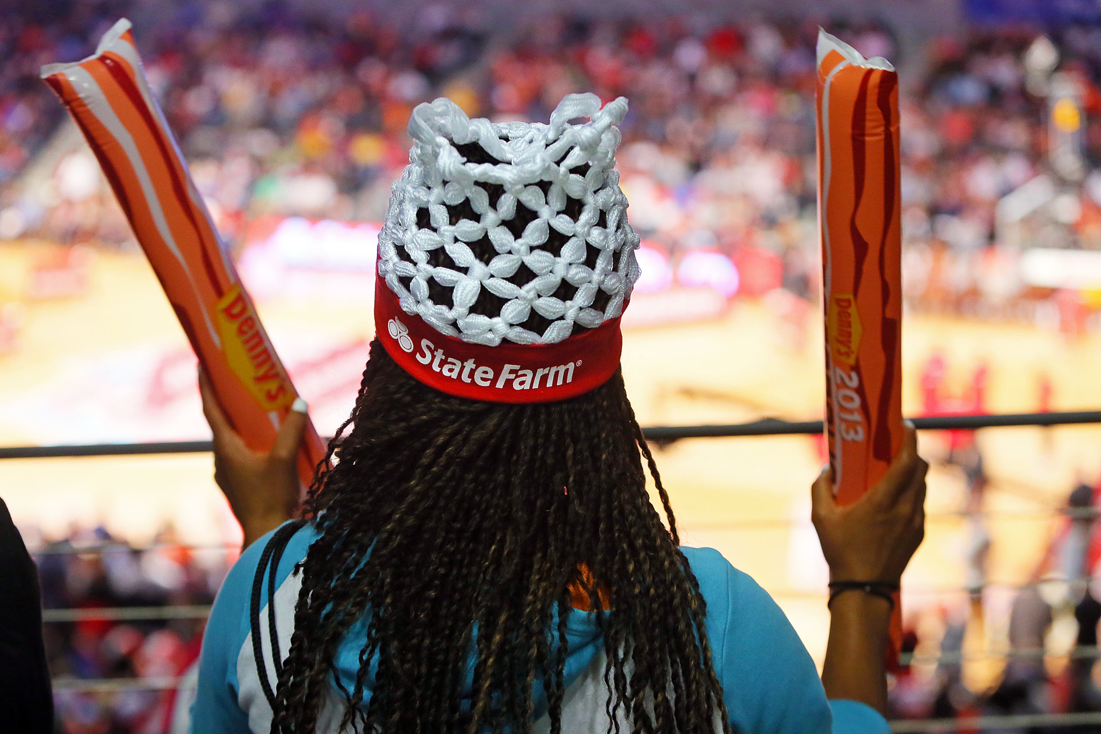 Shamira Harris, Fayetteville, wears a net hat while cheering for competitors at the 25th annual State Farm College Slam Dunk & 3-Point Championships at McCamish Pavilion on Thursday, April 4, 2013, in Atlanta. CURTIS COMPTON / CCOMPTON@AJC.COM