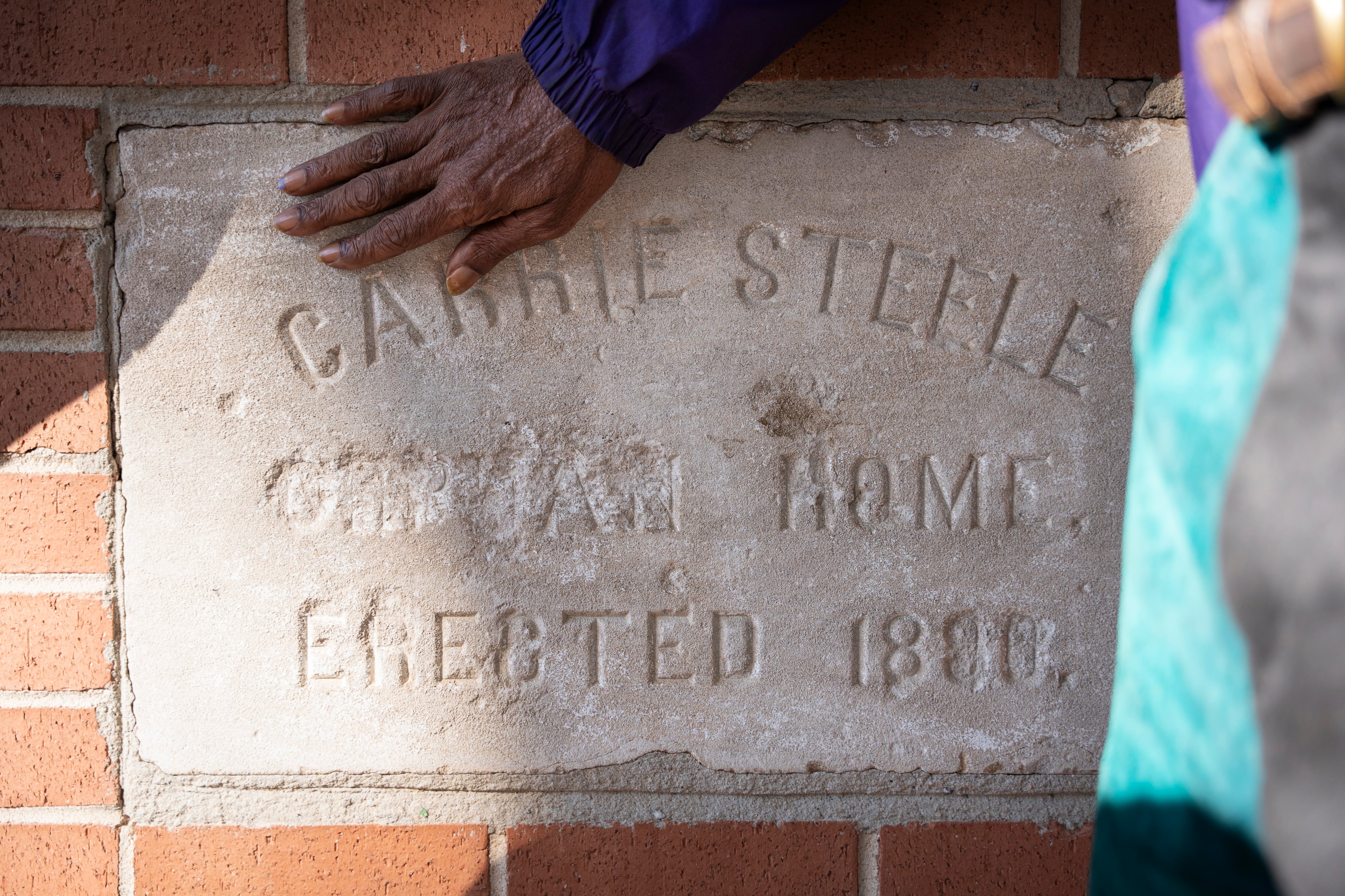 Fernando Jones touches the original sign at the site of the old Carrie Steele-Pitts Home in Atlanta, Georgia on Monday, Feb, 3, 2025. (Olivia Bowdoin for the AJC).