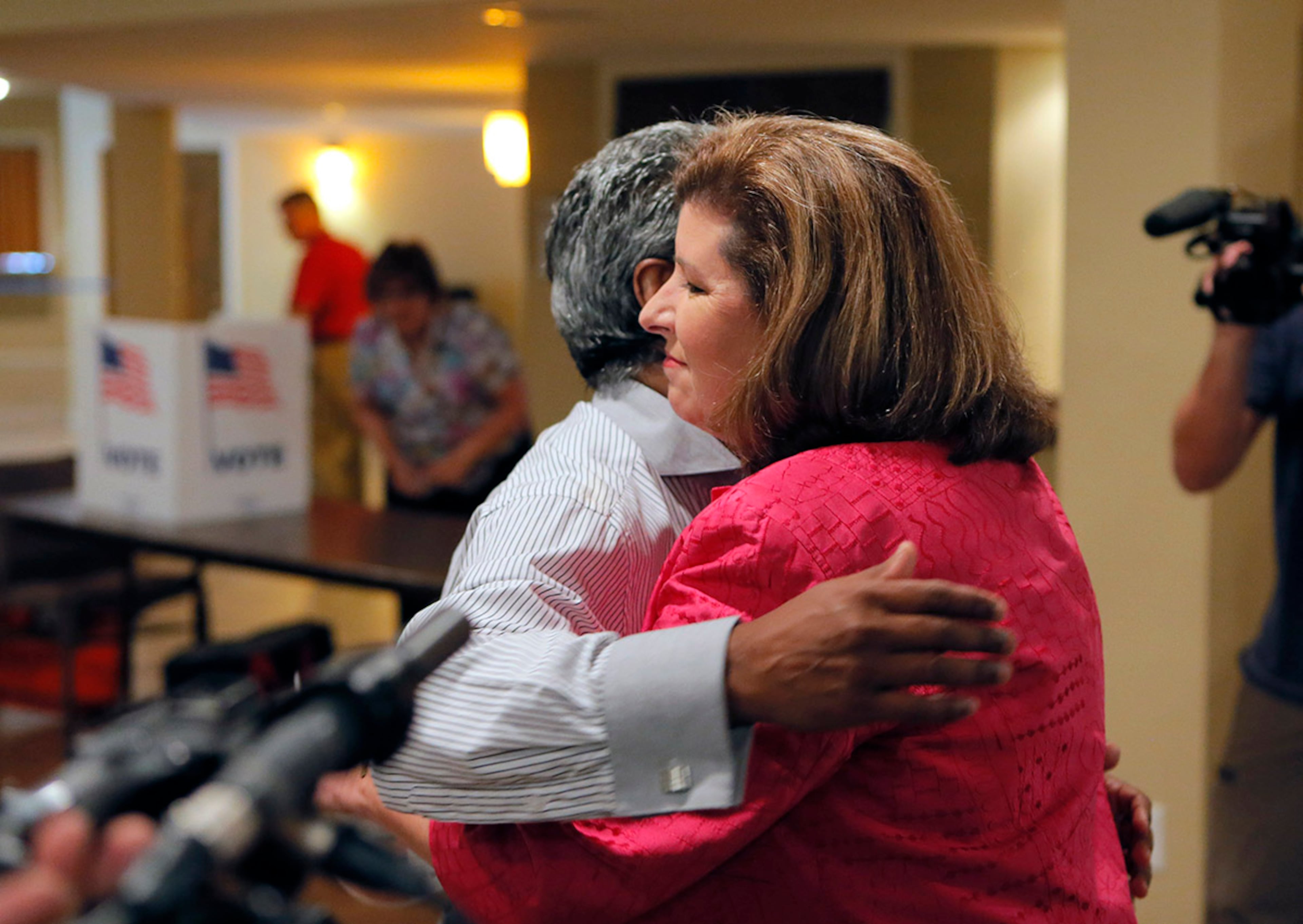 6/20/17 - Roswell, GA - Karen Handel, candidate for Congress, hugs the precinct manager, Neville Billy, who she has known for years from voting at this polling place. She voted in the 6th District Special Election at St Mary's Orthodox Church in Roswell, GA. BOB ANDRES /BANDRES@AJC.COM