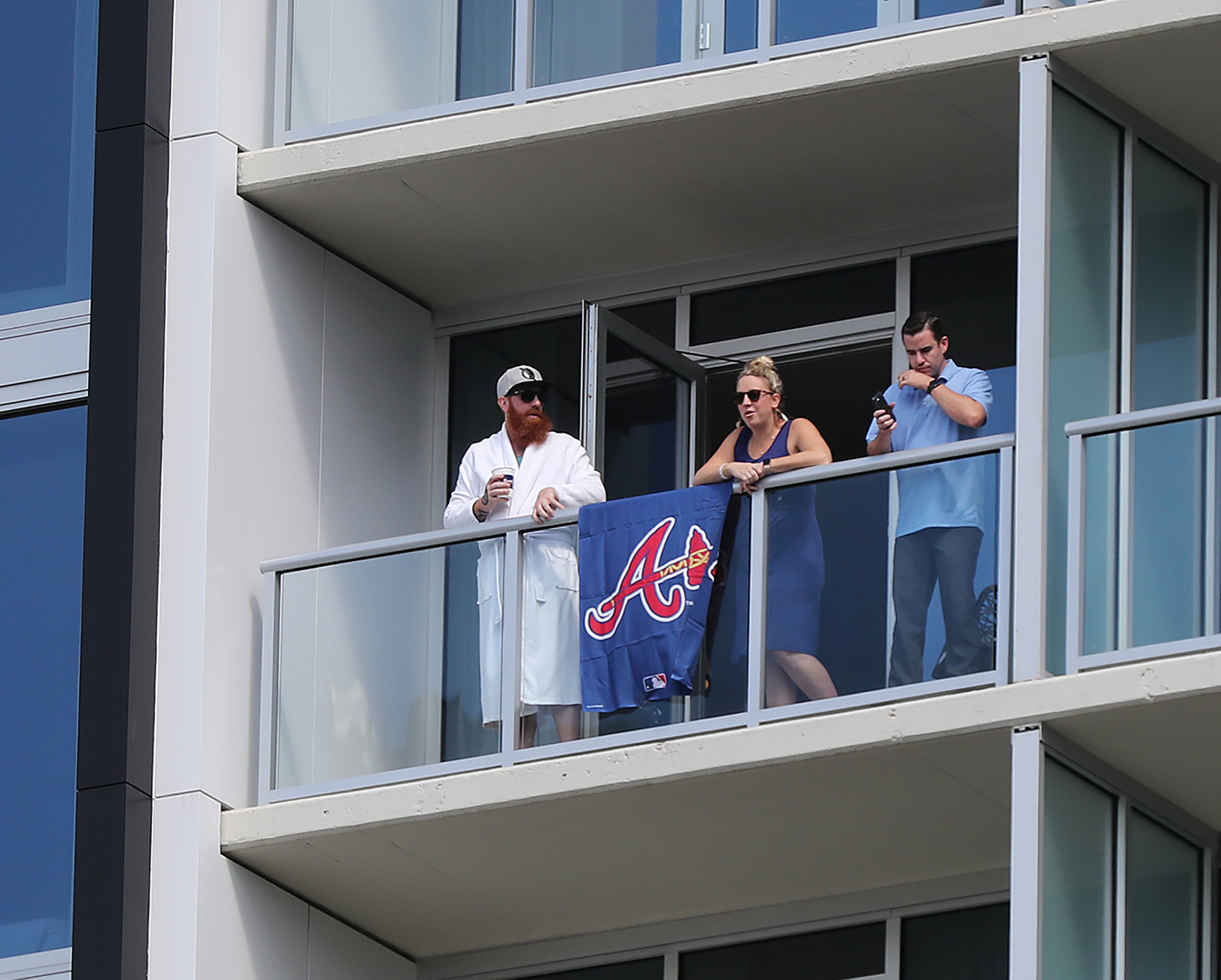 Fans pay the high price for a balcony room at the Omni Hotel overlooking Truist Park to watch Wednesday's home opener against the Rays. (Curtis Compton/ccompton@ajc.com)