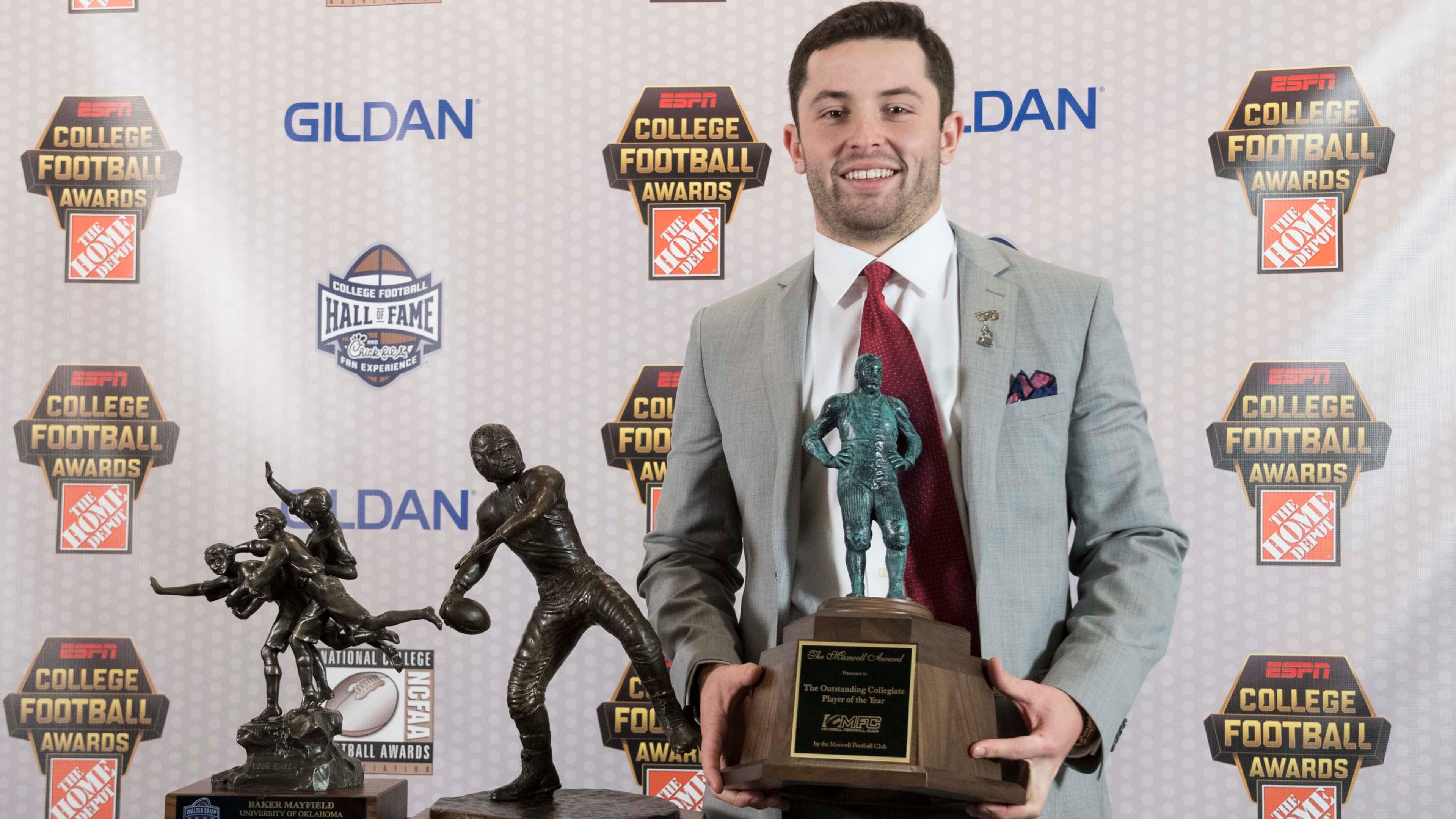 Oklahoma quarterback Baker Mayfield holds the Maxwell Award trophy as he stands next to the Walter Camp and Davey O'Brien awards, which he also won, during the College Football Awards show at the College Football Hall of Fame, Thursday, Dec. 7, 2017, in Atlanta.