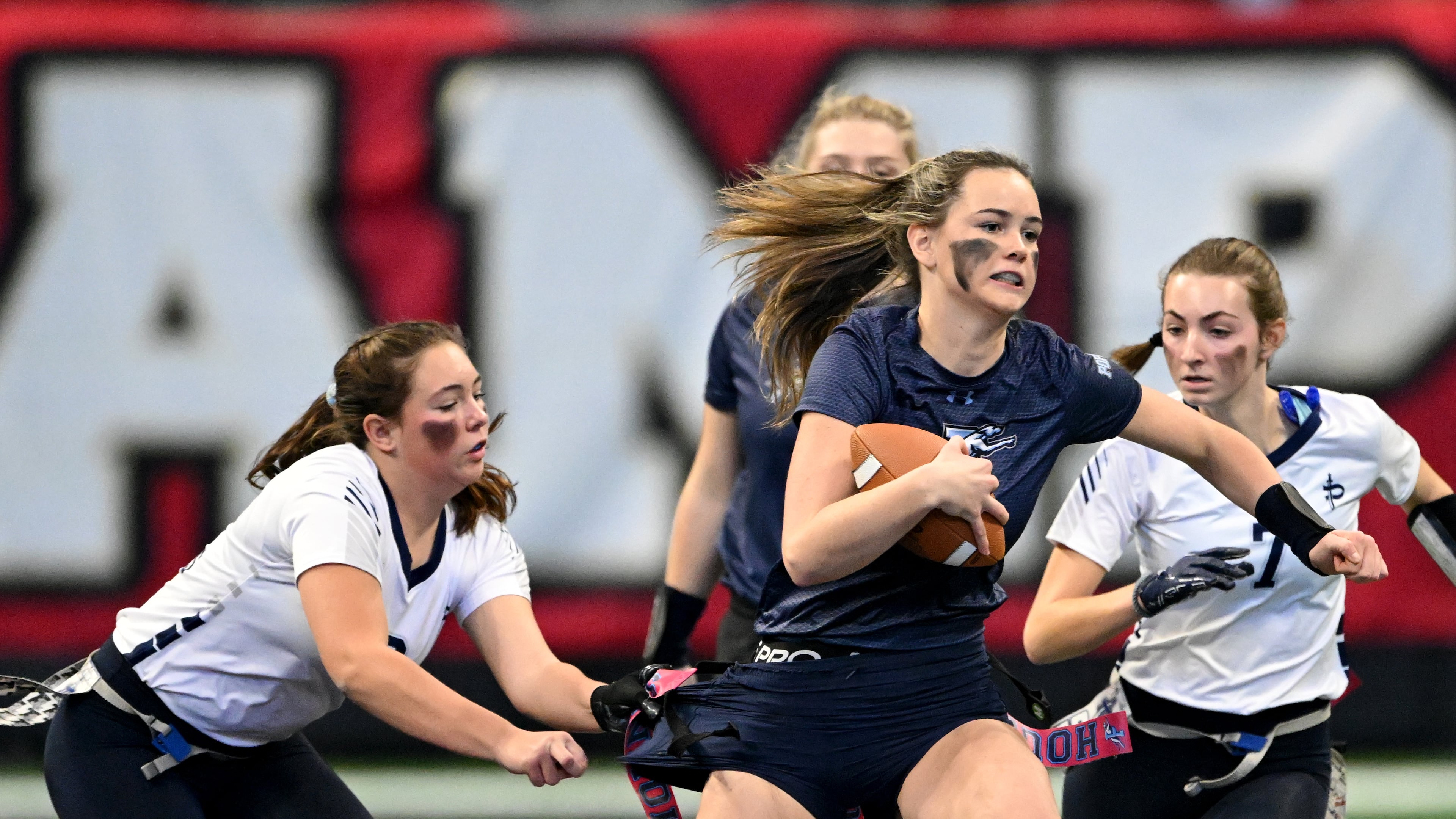 Pope’s Abbey Bensman gets tackled by Pace Academy's Ann Cole Canova (left) during the second half in 2024 GHSA Division 3 Flag Football Championship game at Mercedes-Benz Stadium, Tuesday, December 17, 2024, in Atlanta. Pope won 19-6 over Pace Academy. (Hyosub Shin/AJC)