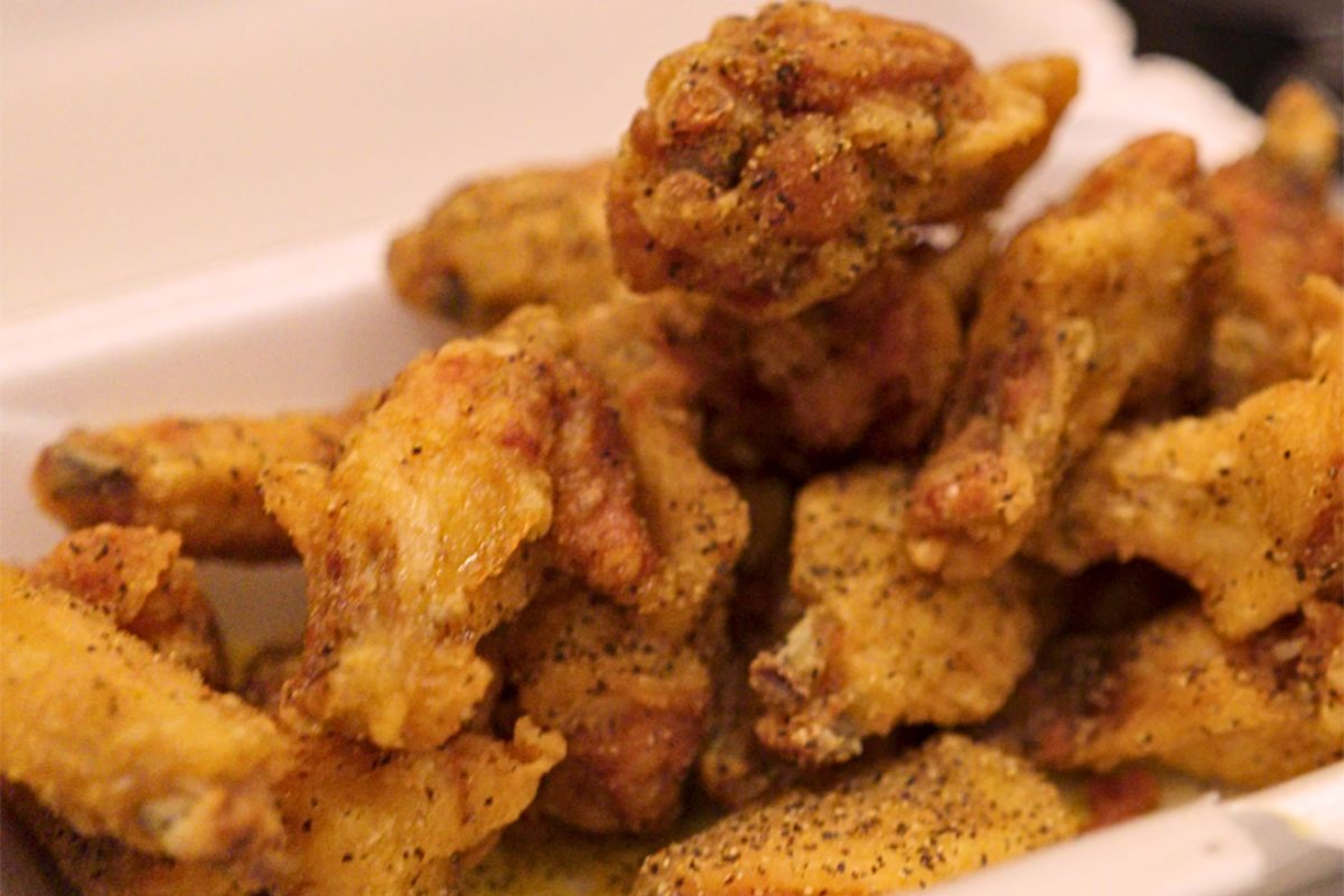 A takeout order of lemon pepper wings, one of eight tested by the AJC Food & Dining team in search of the best in Atlanta. Over a dozen very serious journalists took eating and reviewing wings very seriously for three hours. (Matt Gannon/AJC)