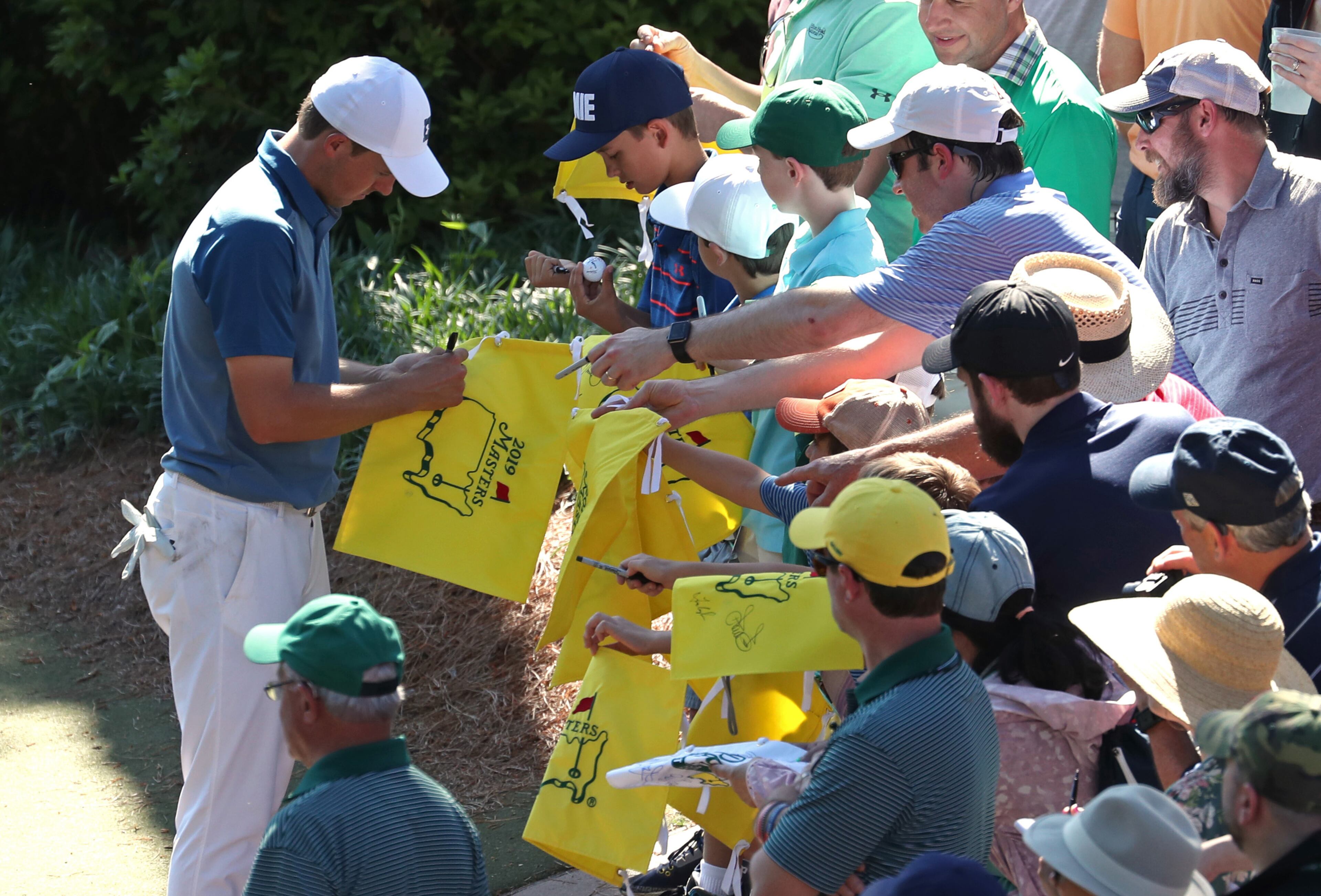 April 10, 2019 - Augusta, Ga: Jordan Spieth signs masters flags for fans after the eighth hole during the Masters' Par 3 Contest Wednesday, April 10, 2019, at Augusta National Golf Club in Augusta. (JASON GETZ/SPECIAL TO THE AJC)