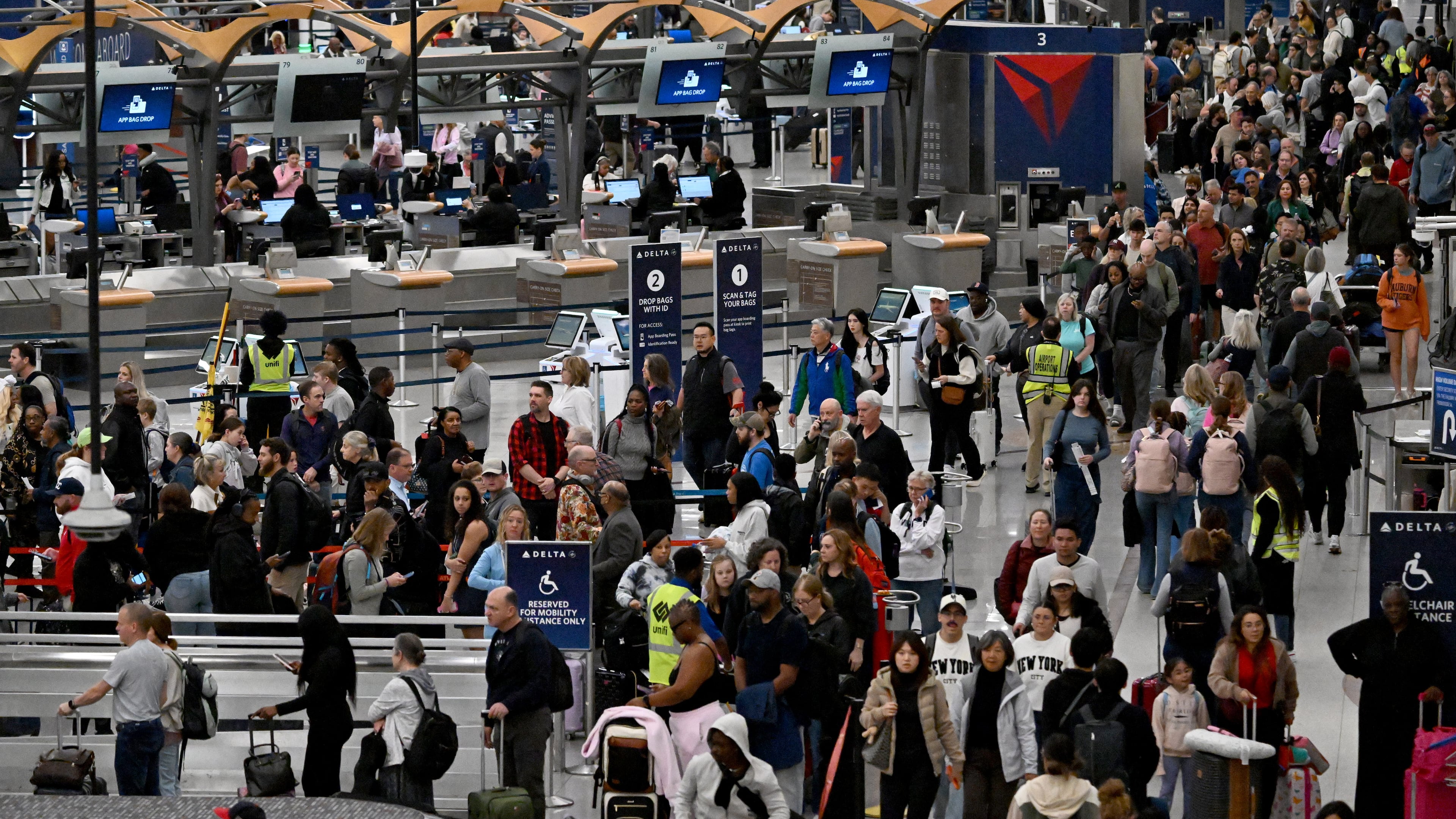Early morning travelers waited in long lines from baggage claim area to get through the TSA security screening amid the partial government shutdown at Hartsfield-Jackson Atlanta International Airport, Saturday, March 21, 2026. (Hyosub Shin/AJC File)