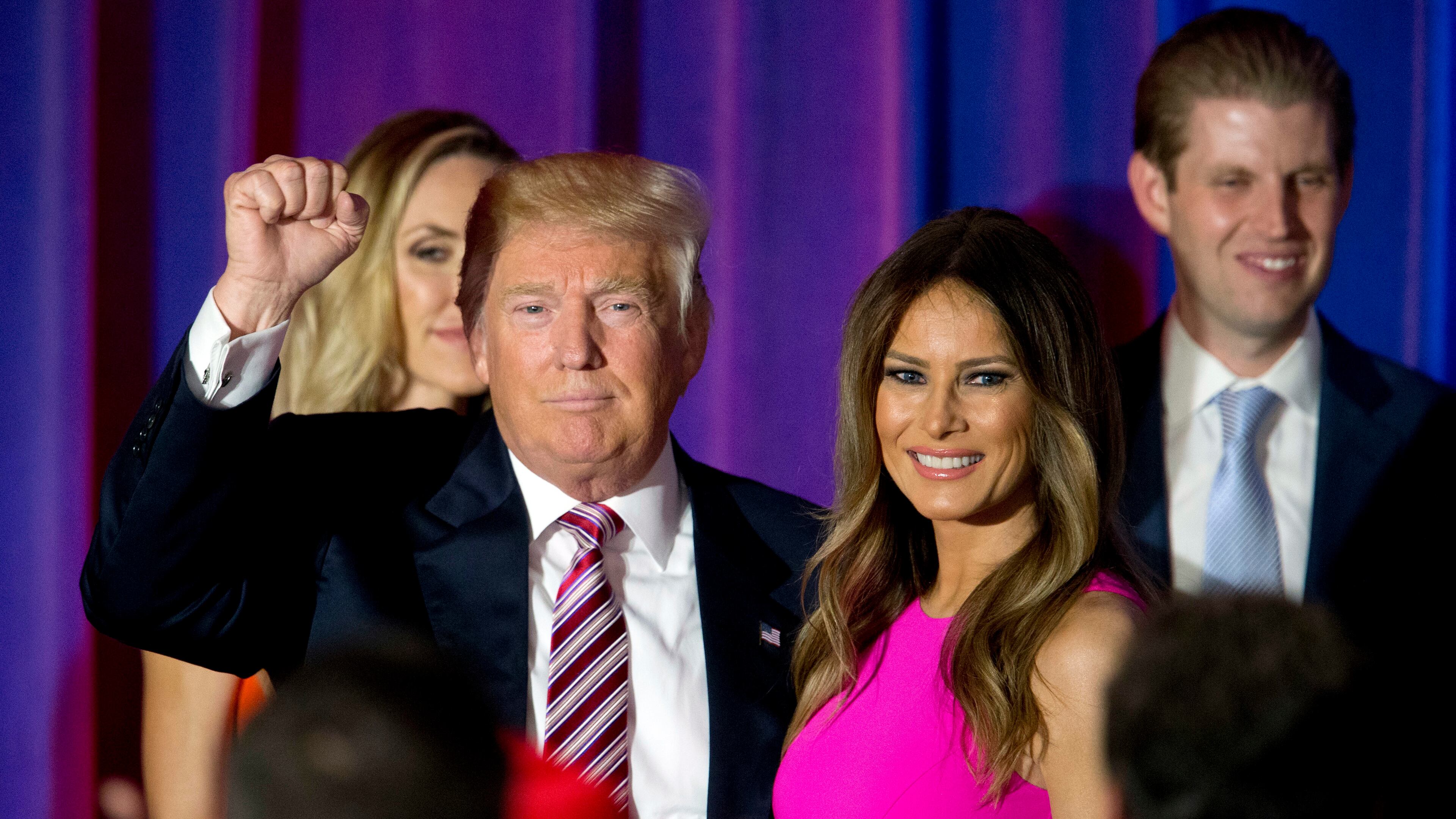 FILE - In this June 7, 2016 file photo, Republican presidential candidate Donald Trump gestures to supporters as he leaves the stage with his wife Melania after a news conference at the Trump National Golf Club Westchester in Briarcliff Manor, N.Y. Melania Trump insists she’s her own person, more than an accessory in her husband Donald Trump’s run for the White House. (AP Photo/Mary Altaffer)