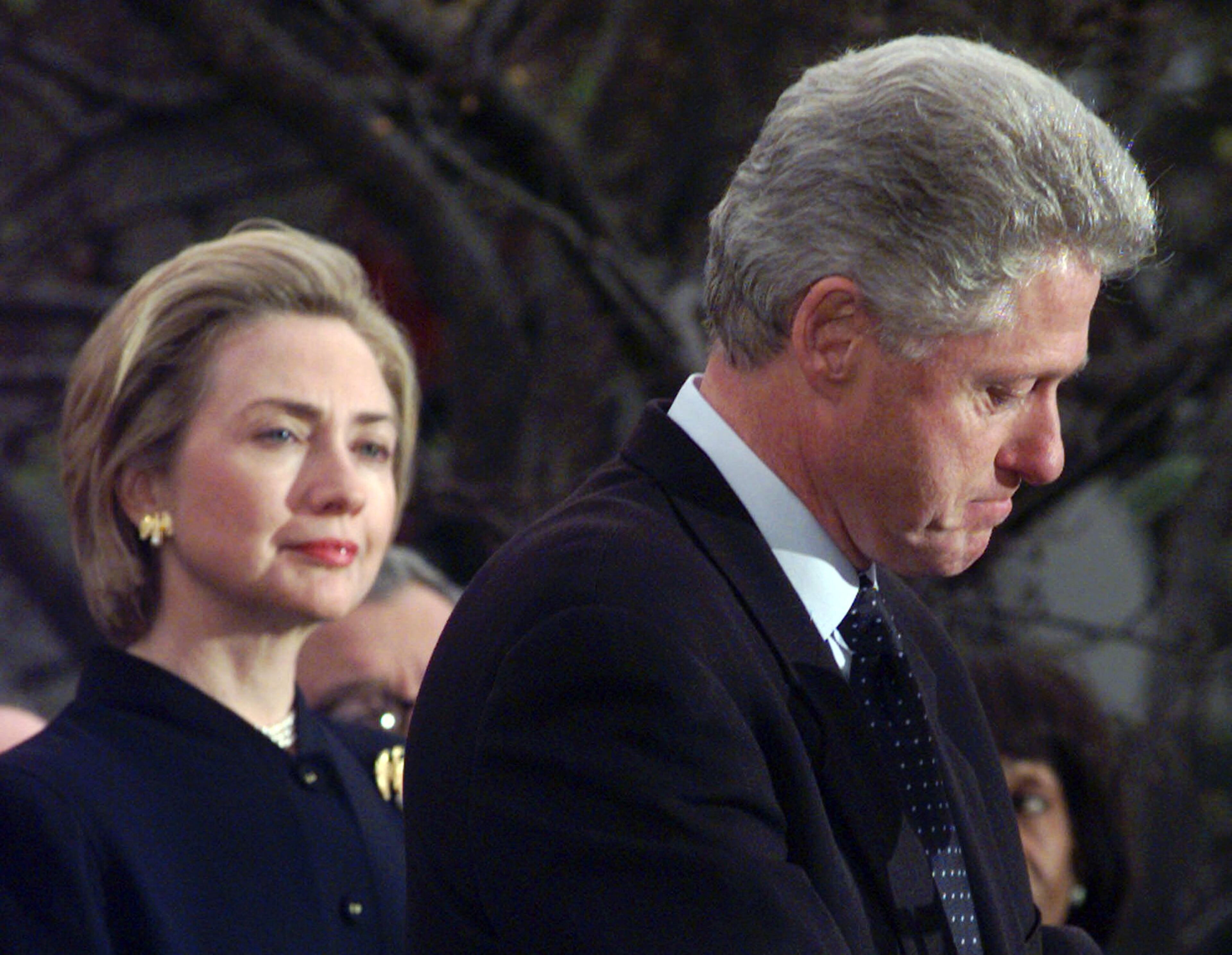 In this Dec. 19, 1998 file photo, First lady Hillary Rodham Clinton watches President Clinton pause as he thanks those Democratic members of the House of Representatives who voted against impeachment. The long-running drama of Hillary Clinton's marriage _ her husband's infidelity and how she dealt with it _ is back as a subtext in this year's presidential race. (AP Photo/Susan Walsh)