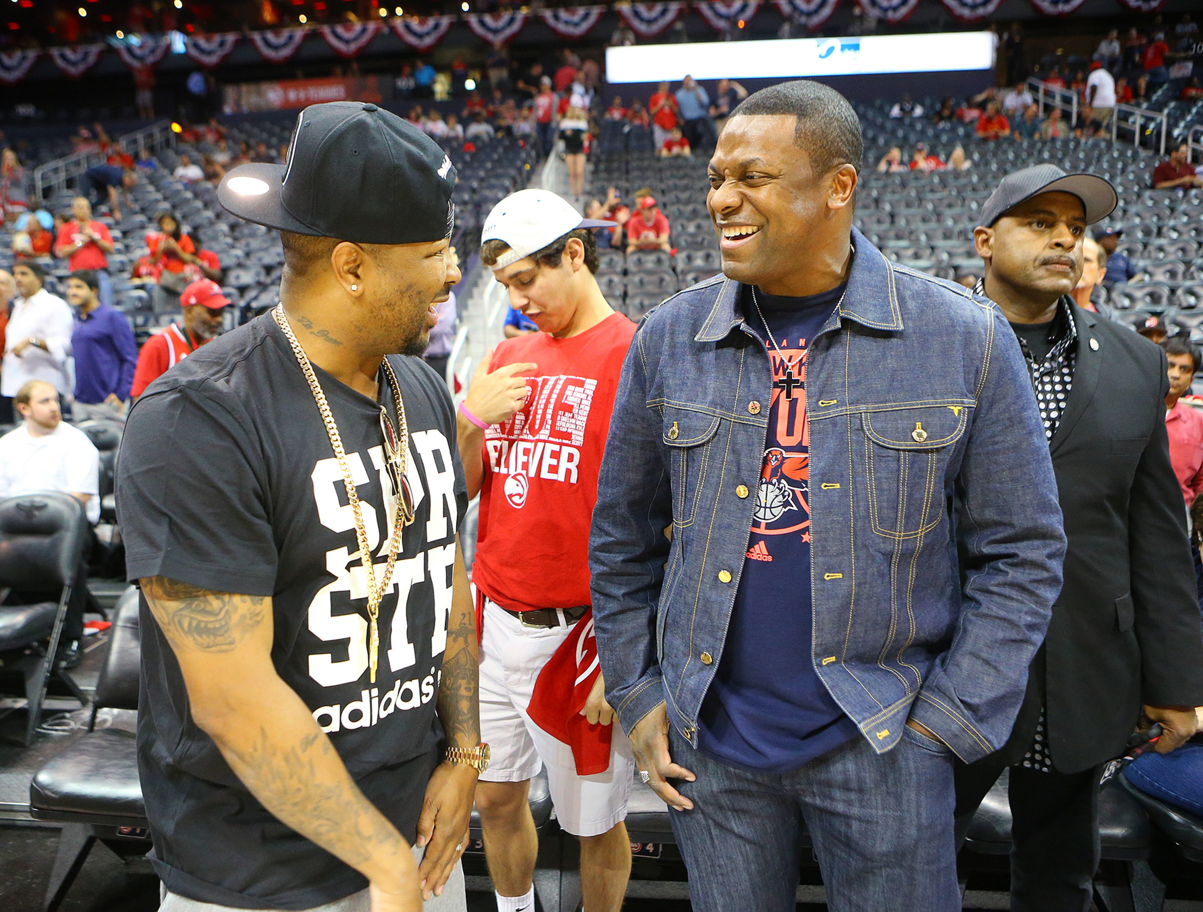 The Dream (left) and Chris Tucker share a laugh court side as the Hawks prepare to play the Wizards in their Eastern Conference Semifinals game 5 on Tuesday, May 13, 2015, in Atlanta. Curtis Compton / ccompton@ajc.com