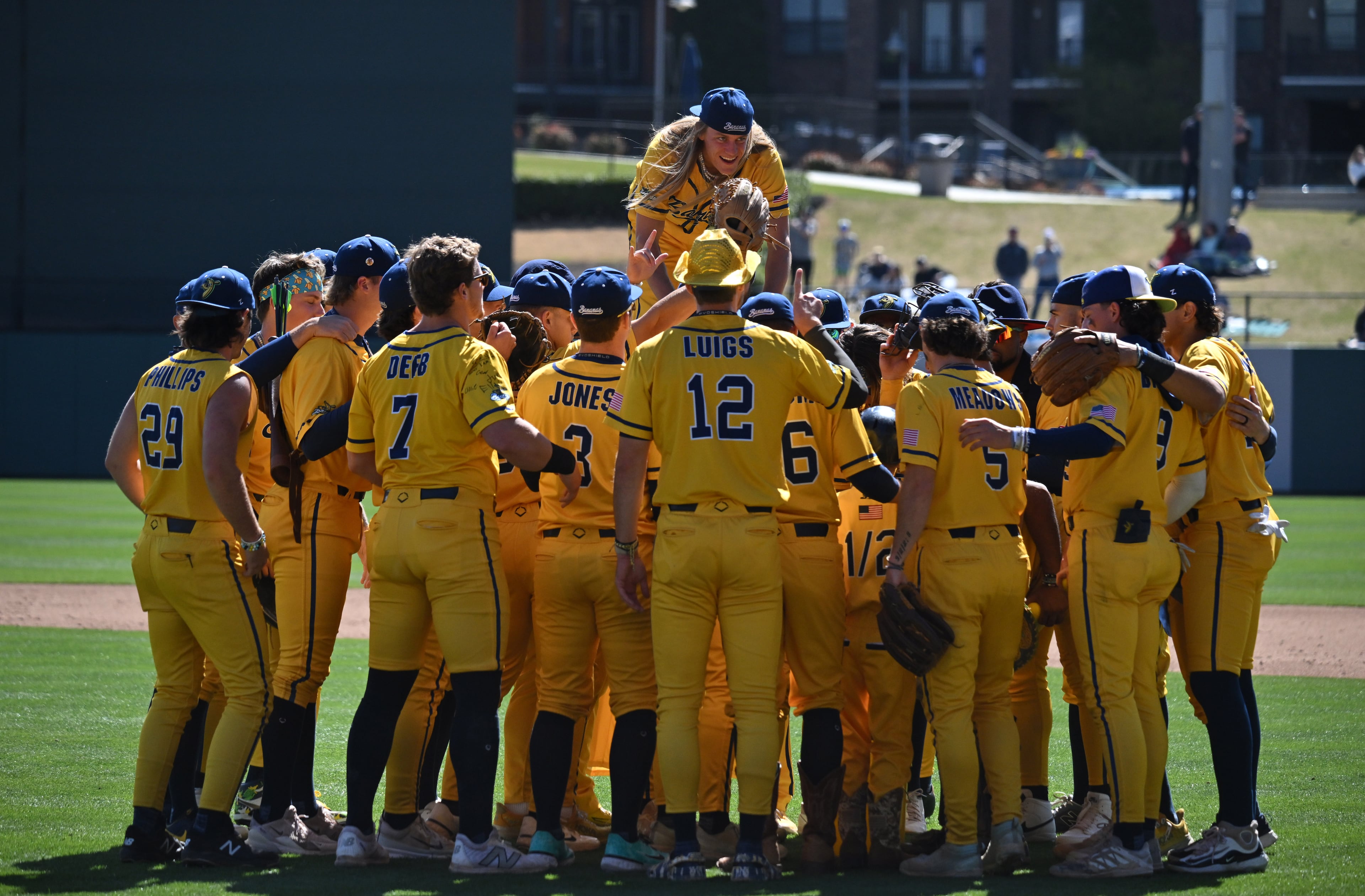 Savannah Bananas get fired up before the first game of a three-game series. (Hyosub Shin / Hyosub.Shin@ajc.com)
