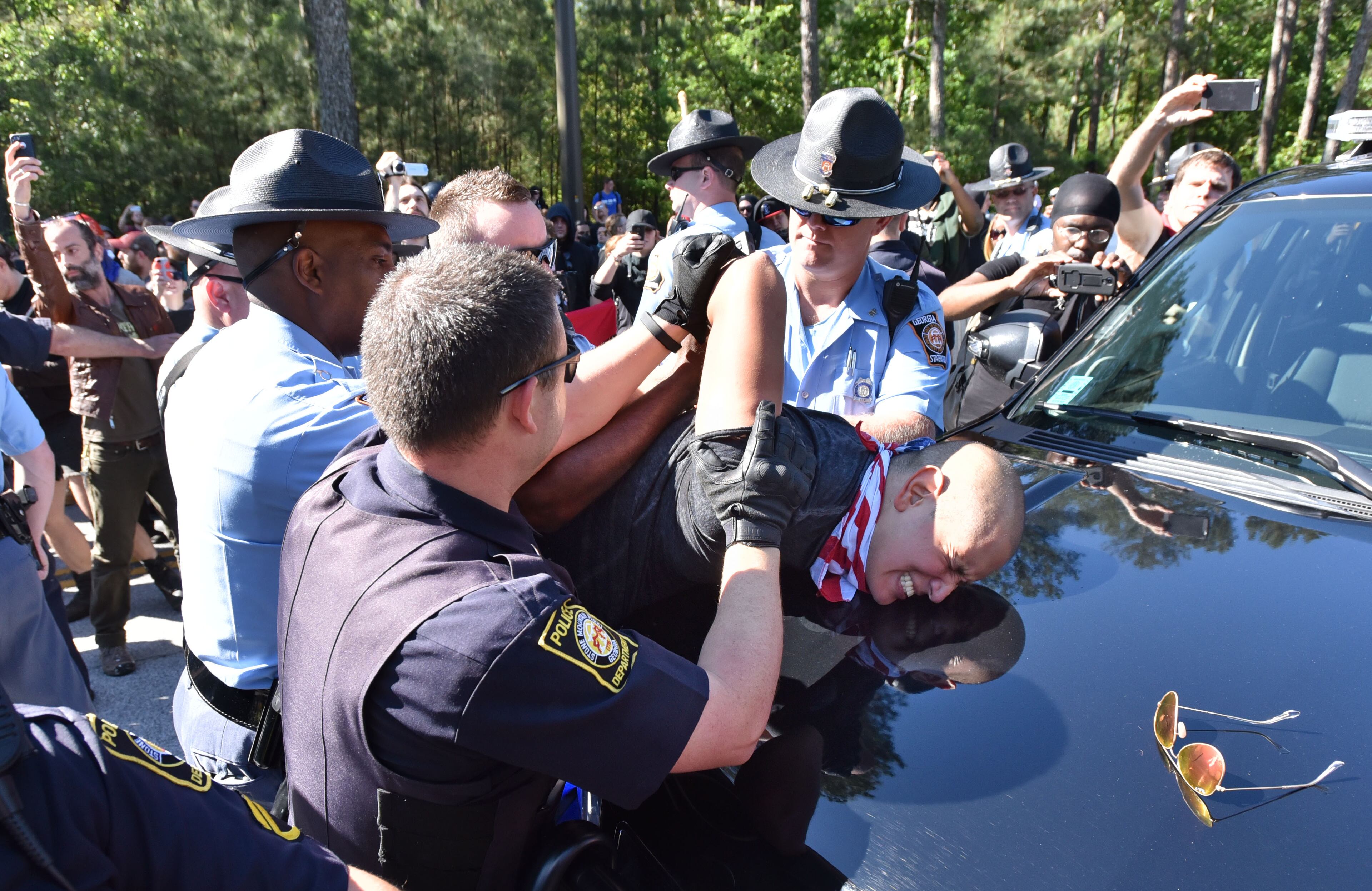 A counter-protester is arrested by police as they try to get past police and to a white power protest at Stone Mountain Park on Saturday, April 23, 2016.