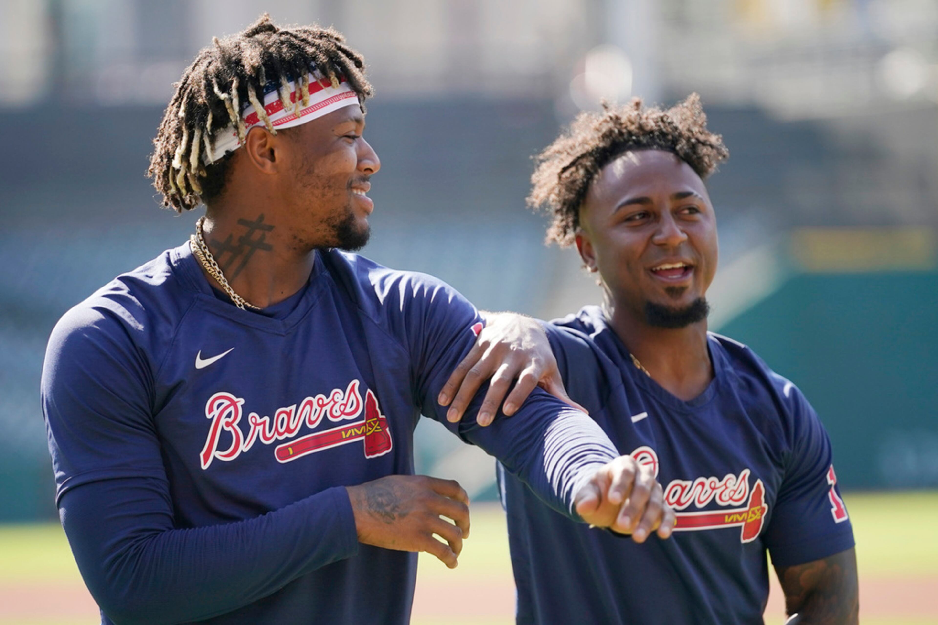 Atlanta Braves' Ronald Acuna Jr., left, and Ozzie Albies, right, talk before a baseball game against the Cleveland Guardians, Tuesday, July 4, 2023, in Cleveland. (AP Photo/Sue Ogrocki)